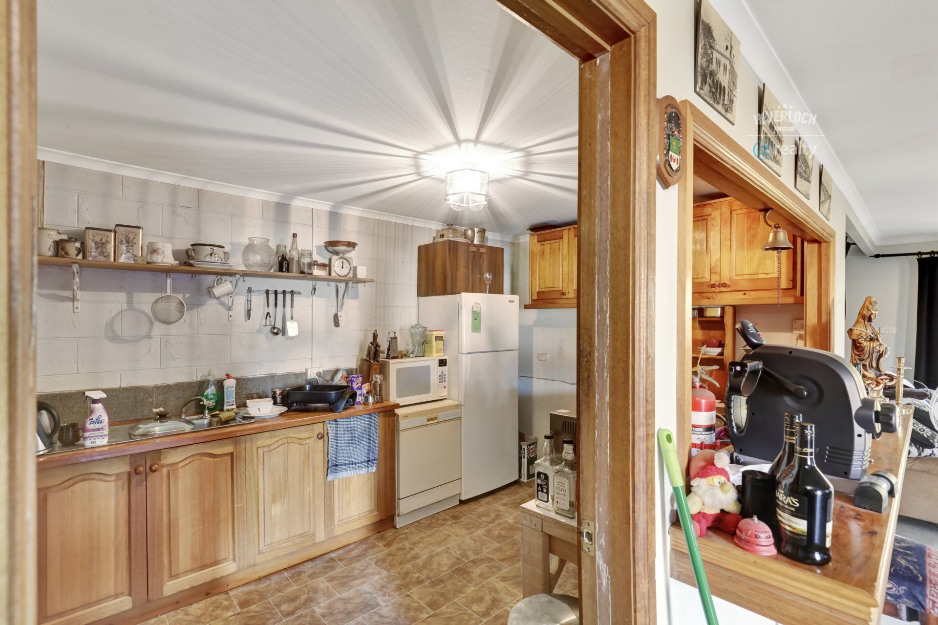 A kitchen with wooden cabinets and a refrigerator.
