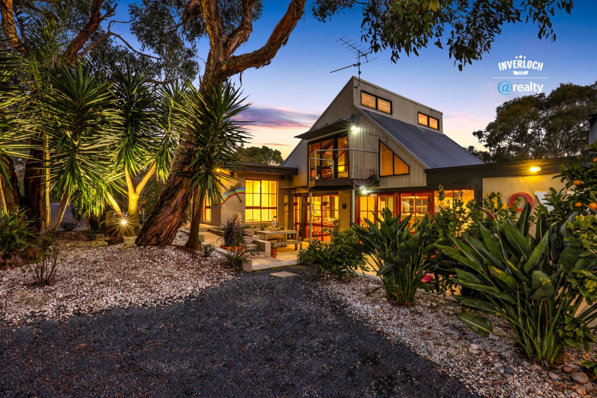 A large house with a lot of windows and trees in front of it