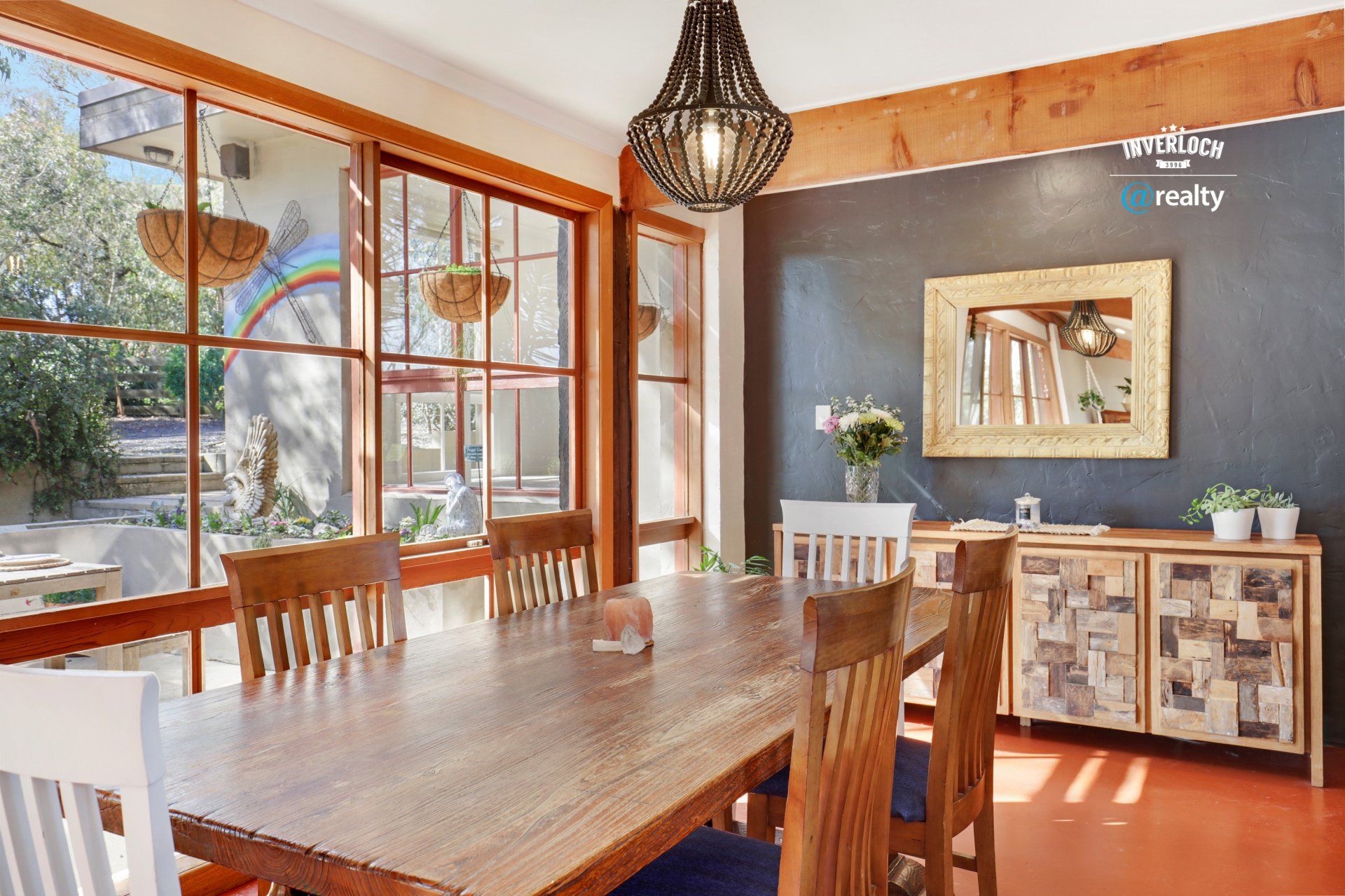 A dining room with a large wooden table and chairs