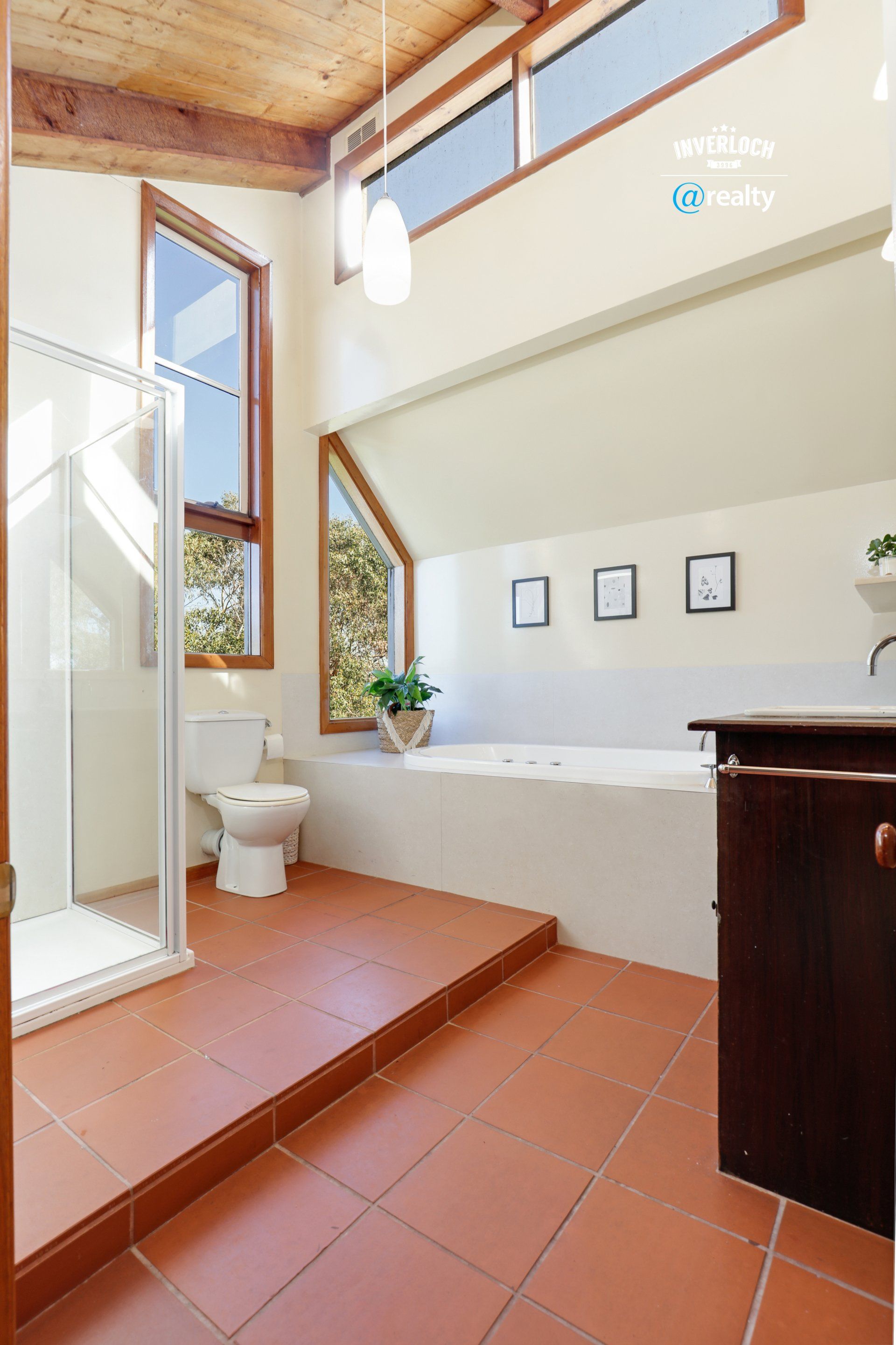 A bathroom with a toilet , sink , tub and shower.