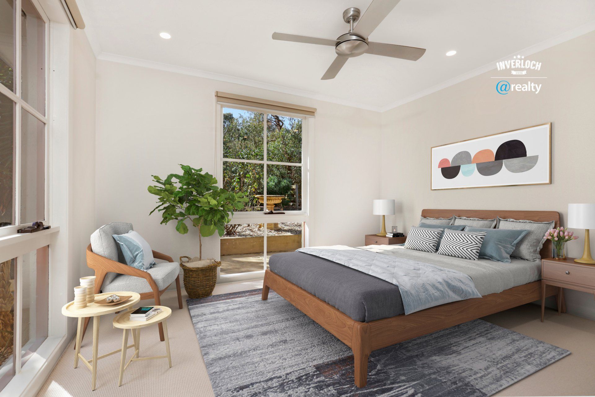 A bedroom with a bed , chair , table and ceiling fan.