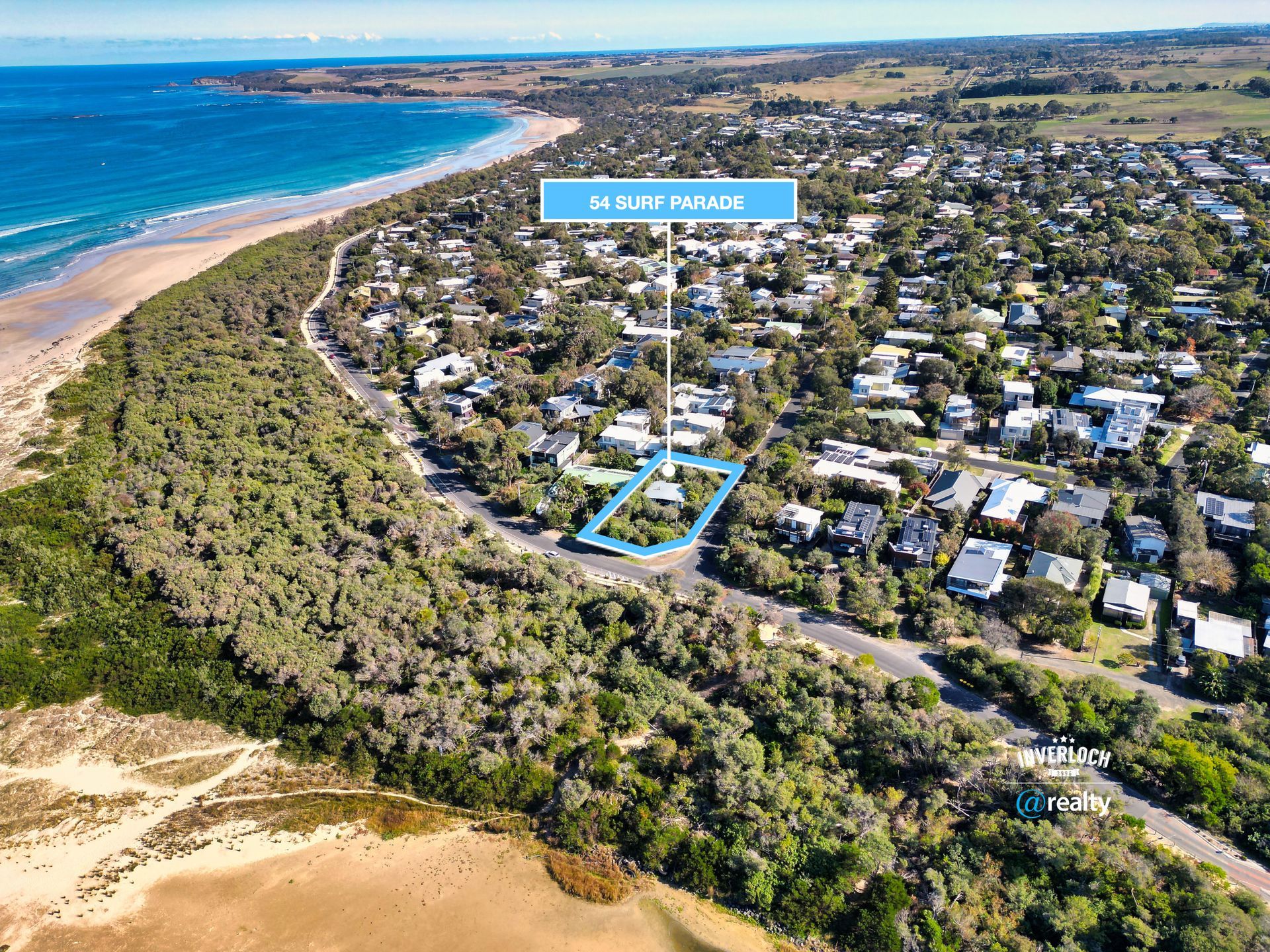 An aerial view of a residential area next to the ocean.