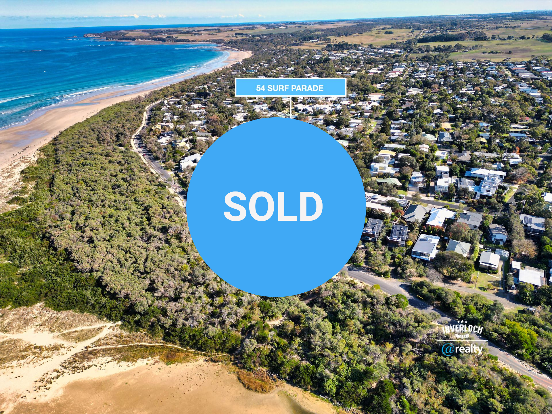 An aerial view of a residential area next to the ocean.