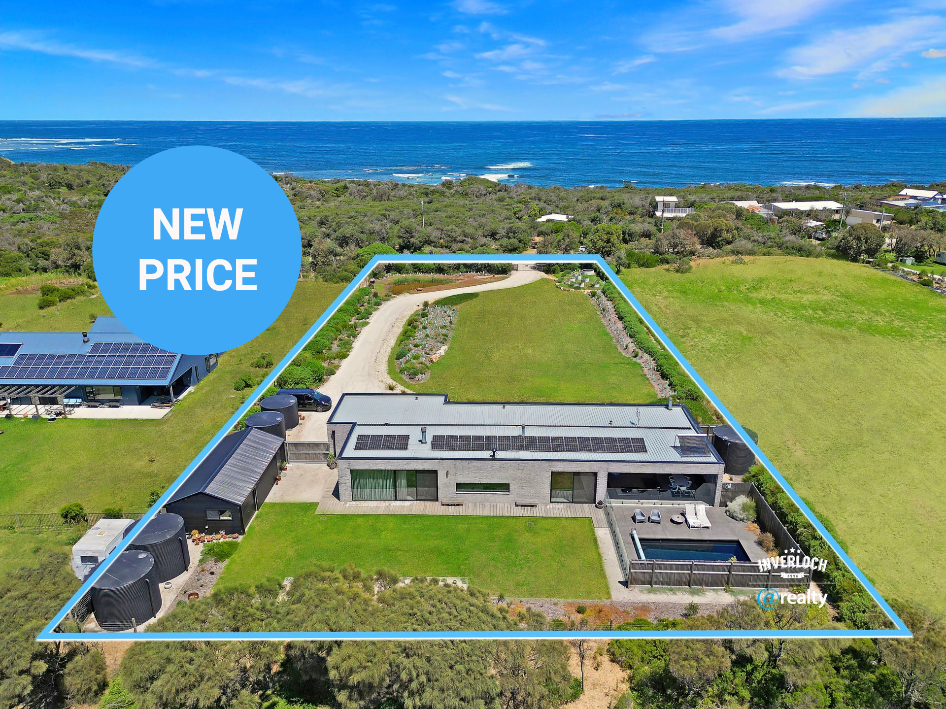 An aerial view of a large house with a view of the ocean.