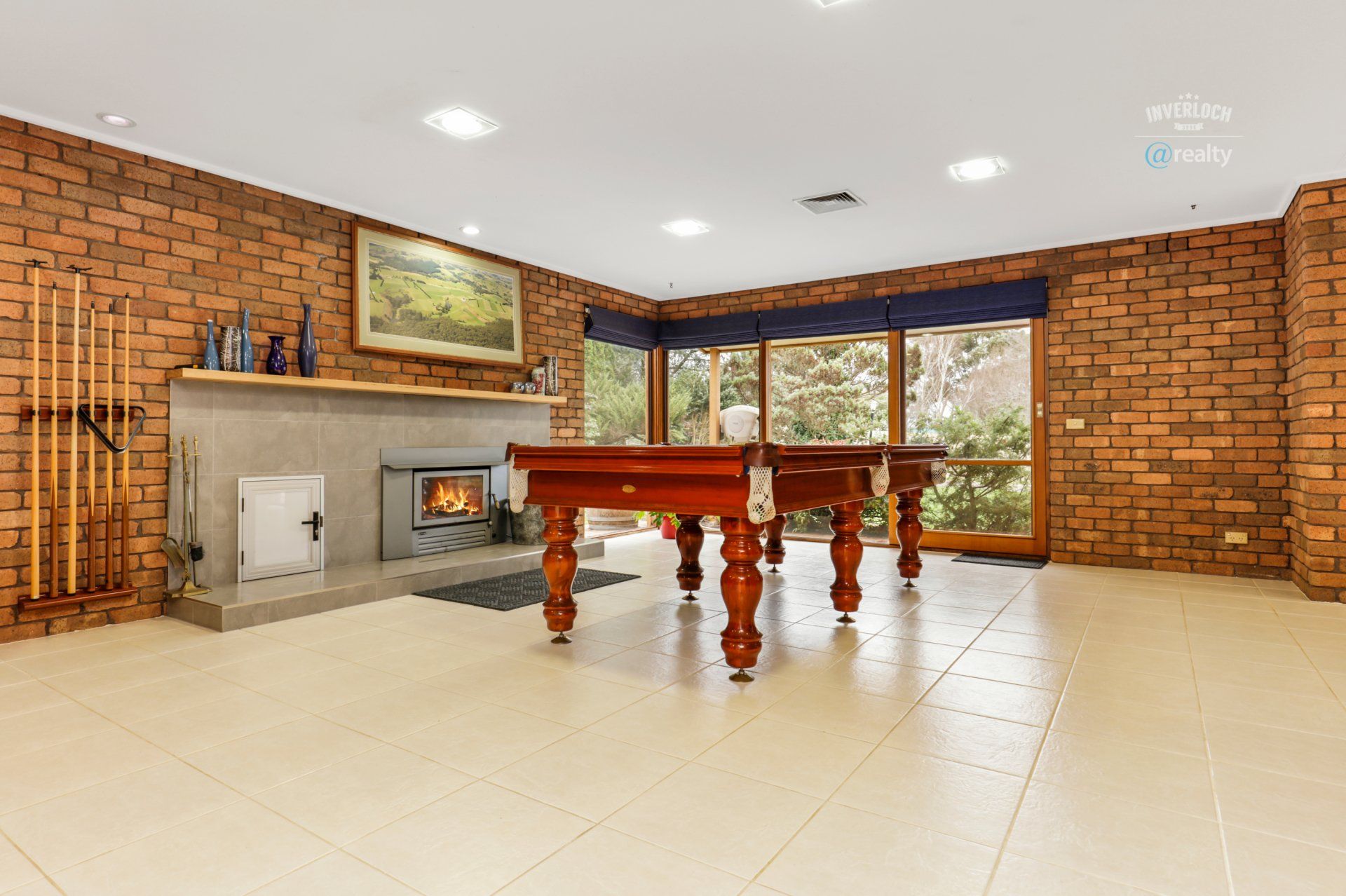 There is a pool table in the middle of the room.