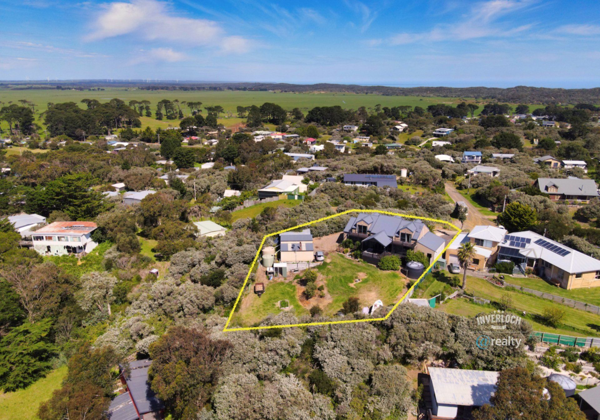 An aerial view of a residential area with houses and trees.