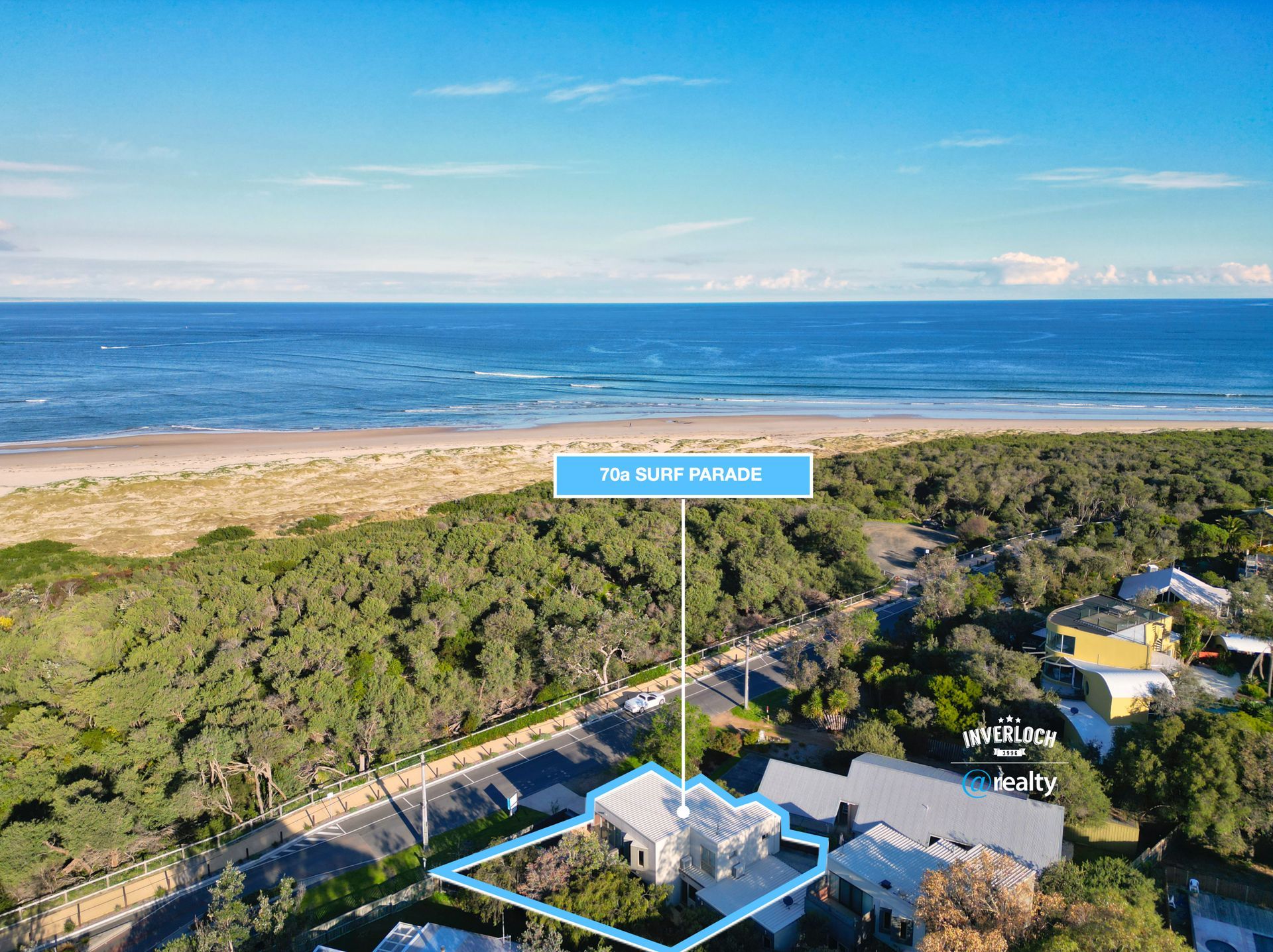 An aerial view of a house next to a beach.