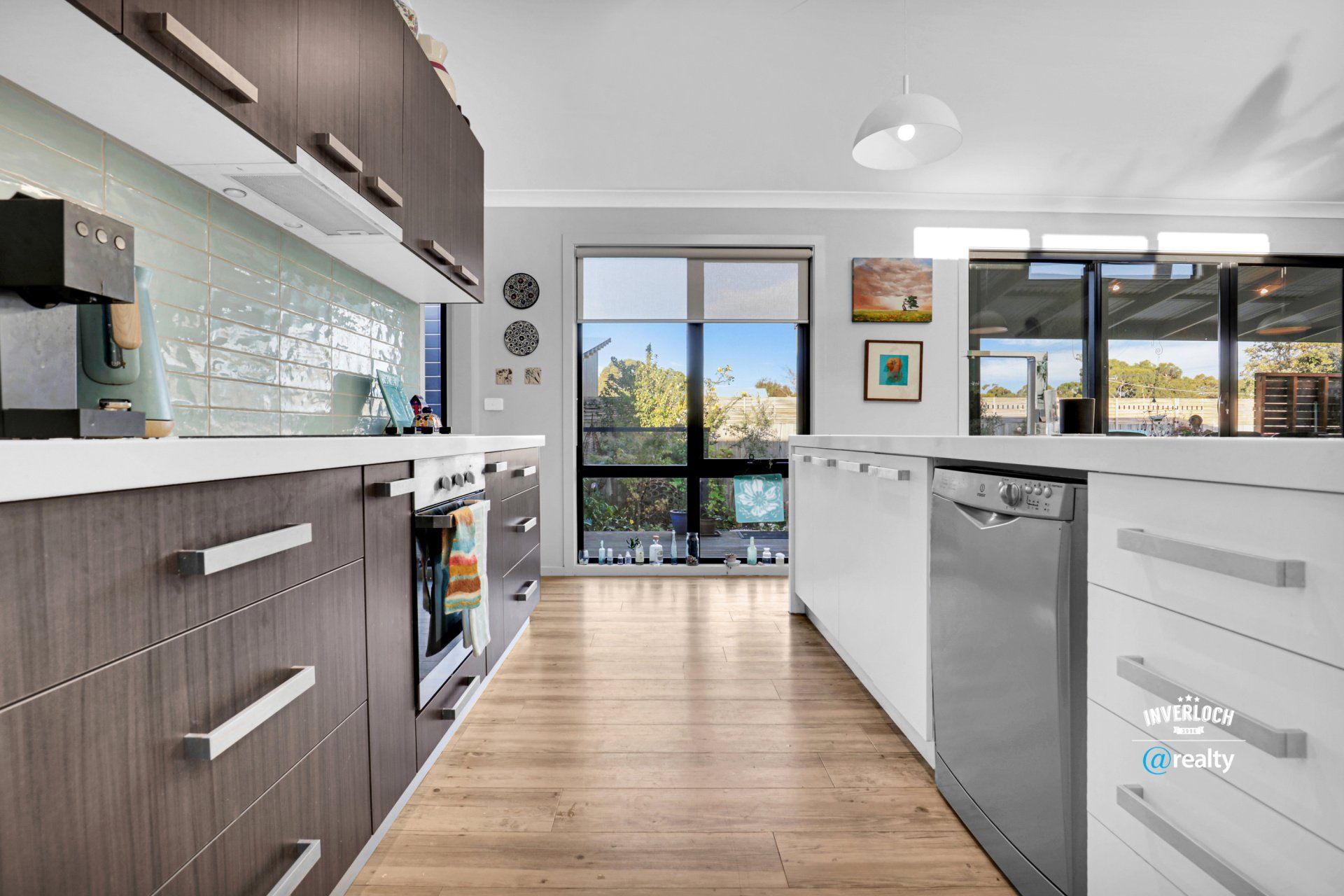 A kitchen with stainless steel appliances and wooden cabinets.