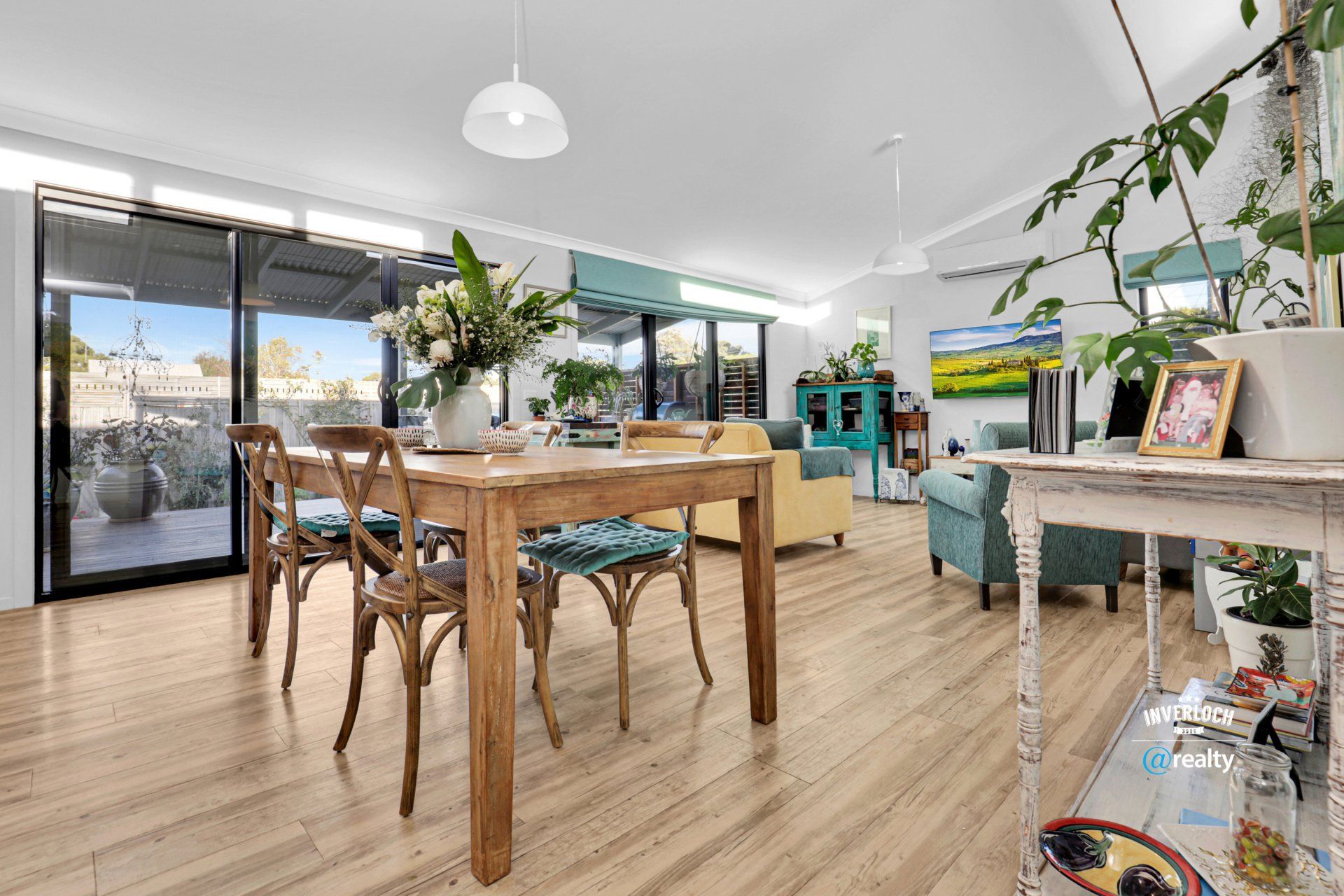 A large living room with a wooden table and chairs.