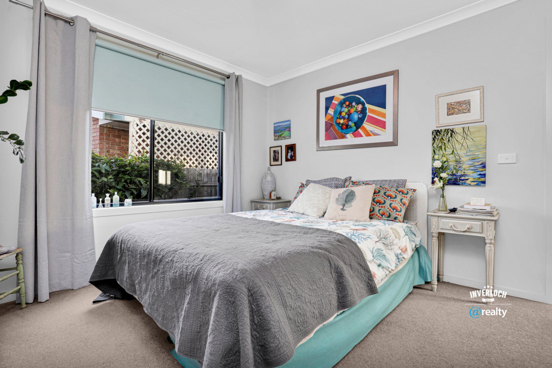 A bedroom with a large bed and a window.