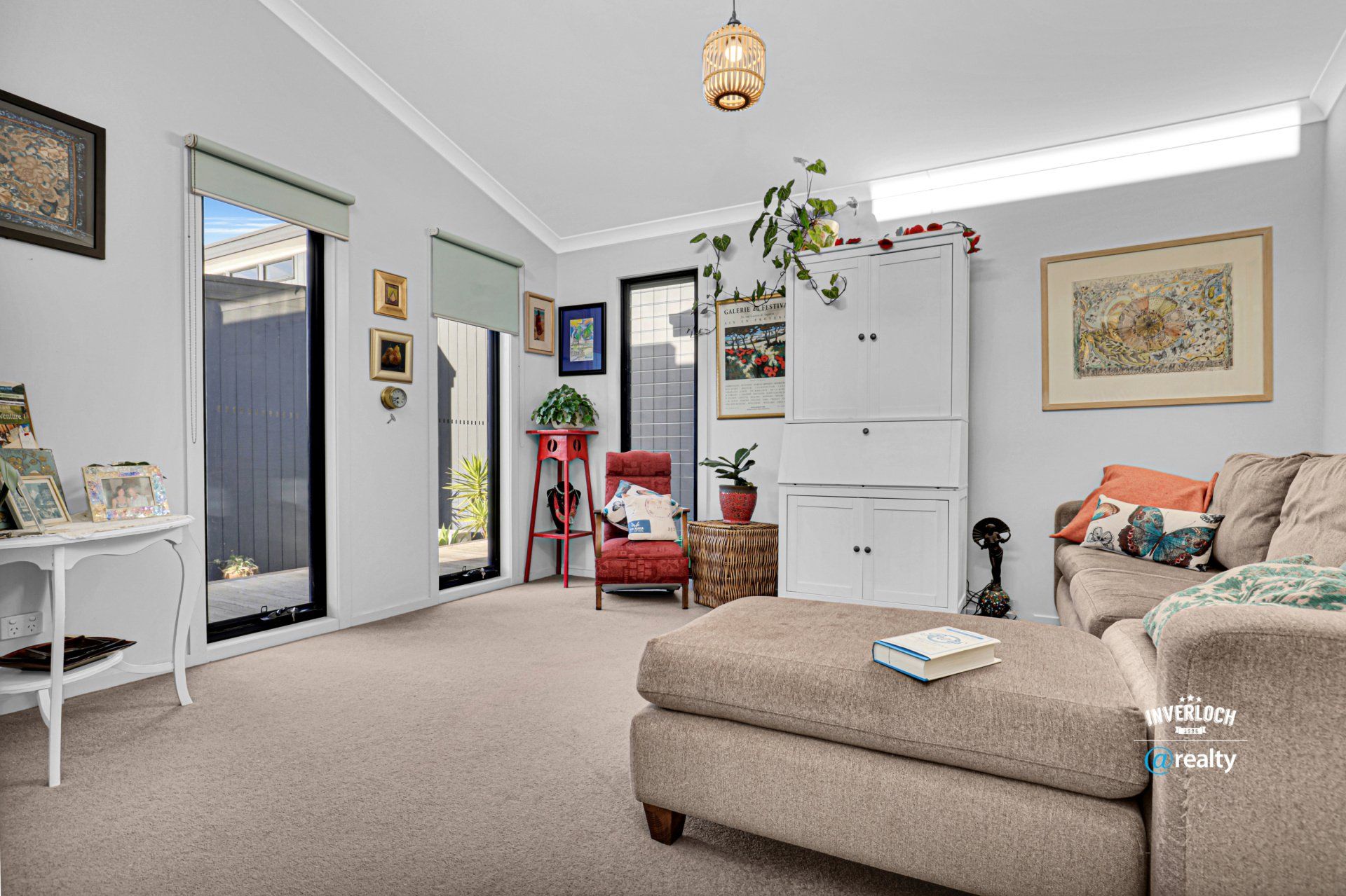 A living room with a couch , chair and ottoman.