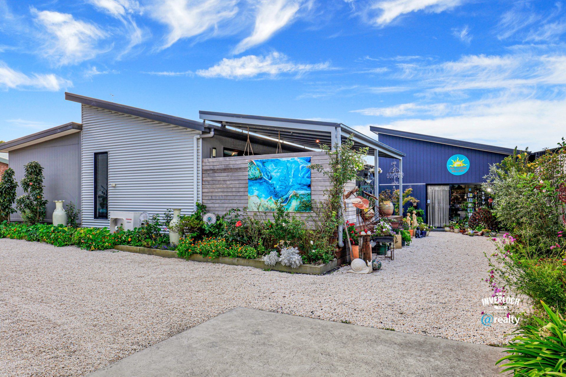 A large house with a lot of plants in front of it.
