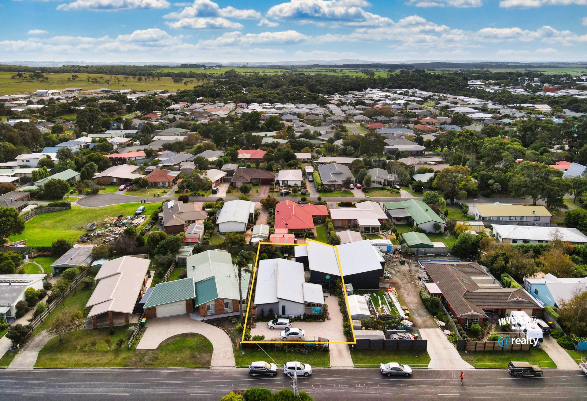 An aerial view of a residential area with lots of houses and a road.