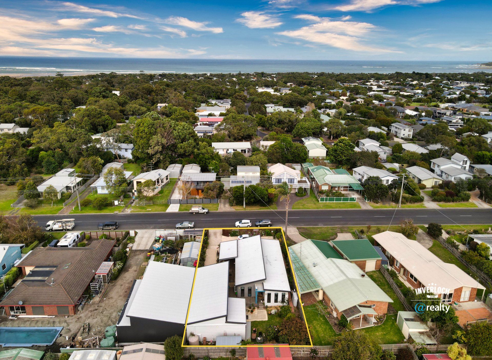 An aerial view of a residential area next to the ocean.