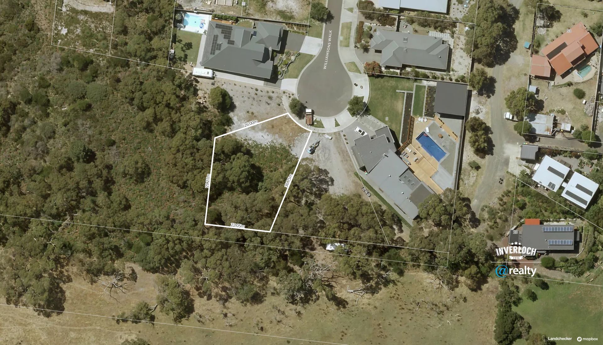 An aerial view of a residential area with houses and trees