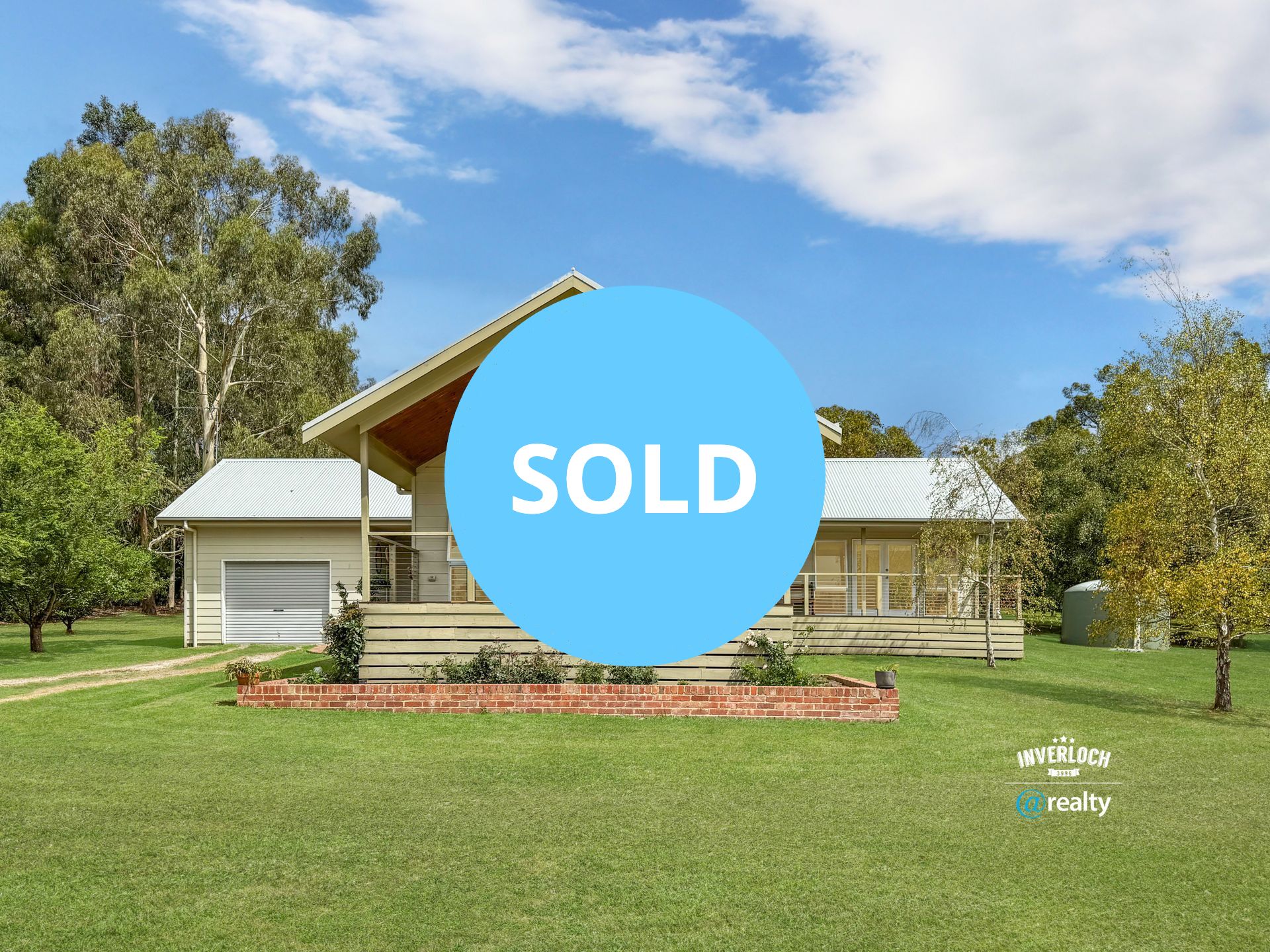 A house with a sold sign in front of it