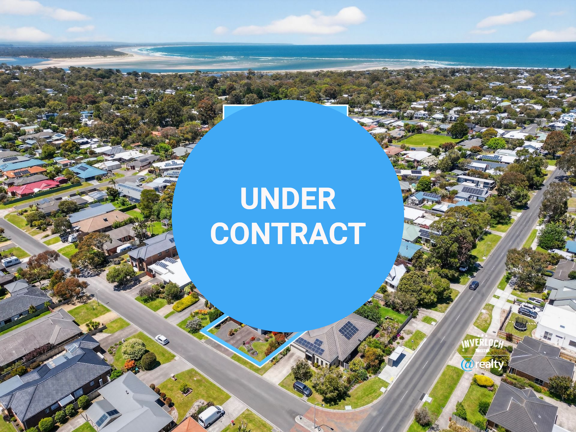 Aerial view of residential homes in a coastal town, with the ocean in the background and a property highlighted.