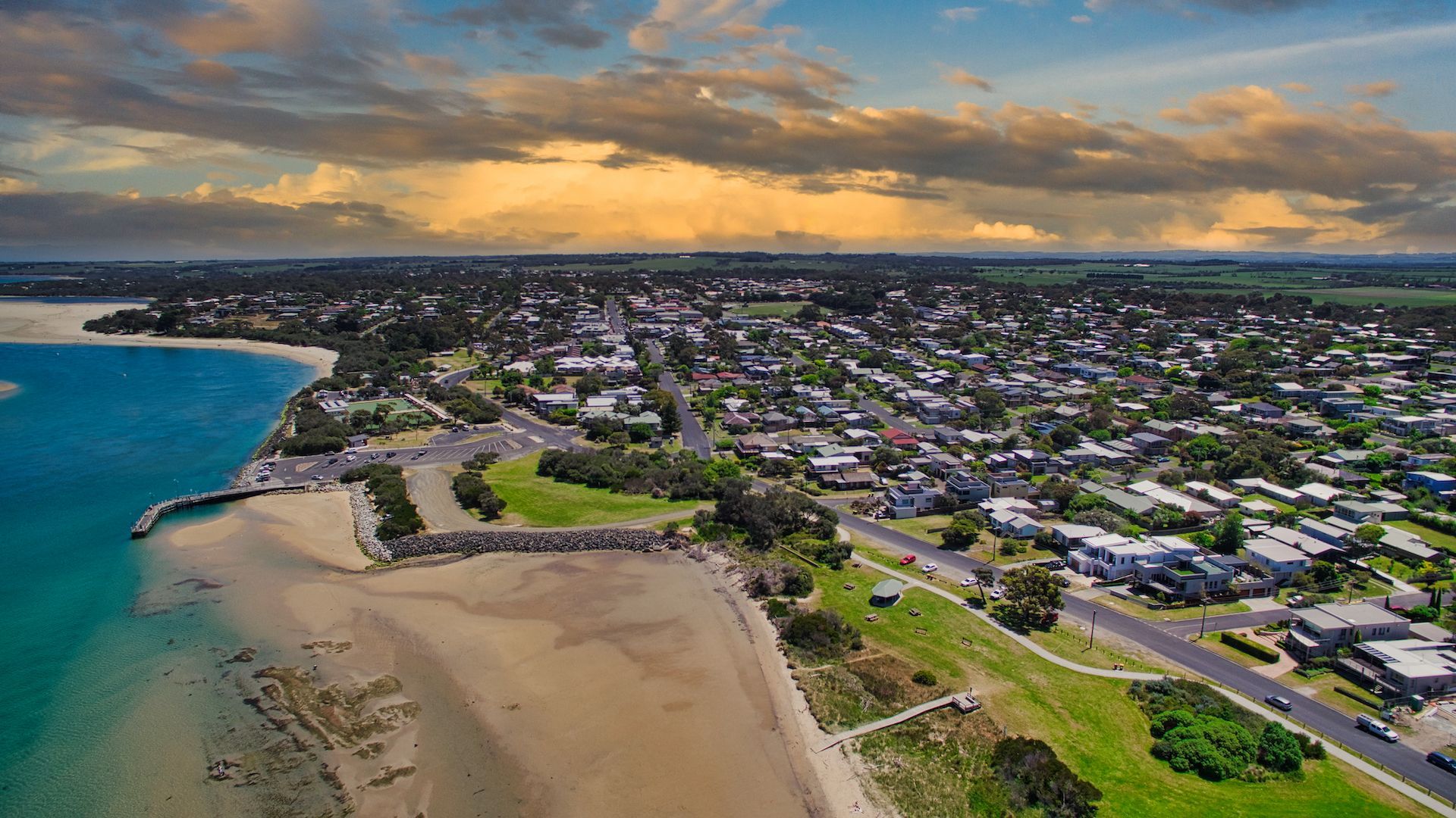 An aerial view of Inverloch next to a body of water.