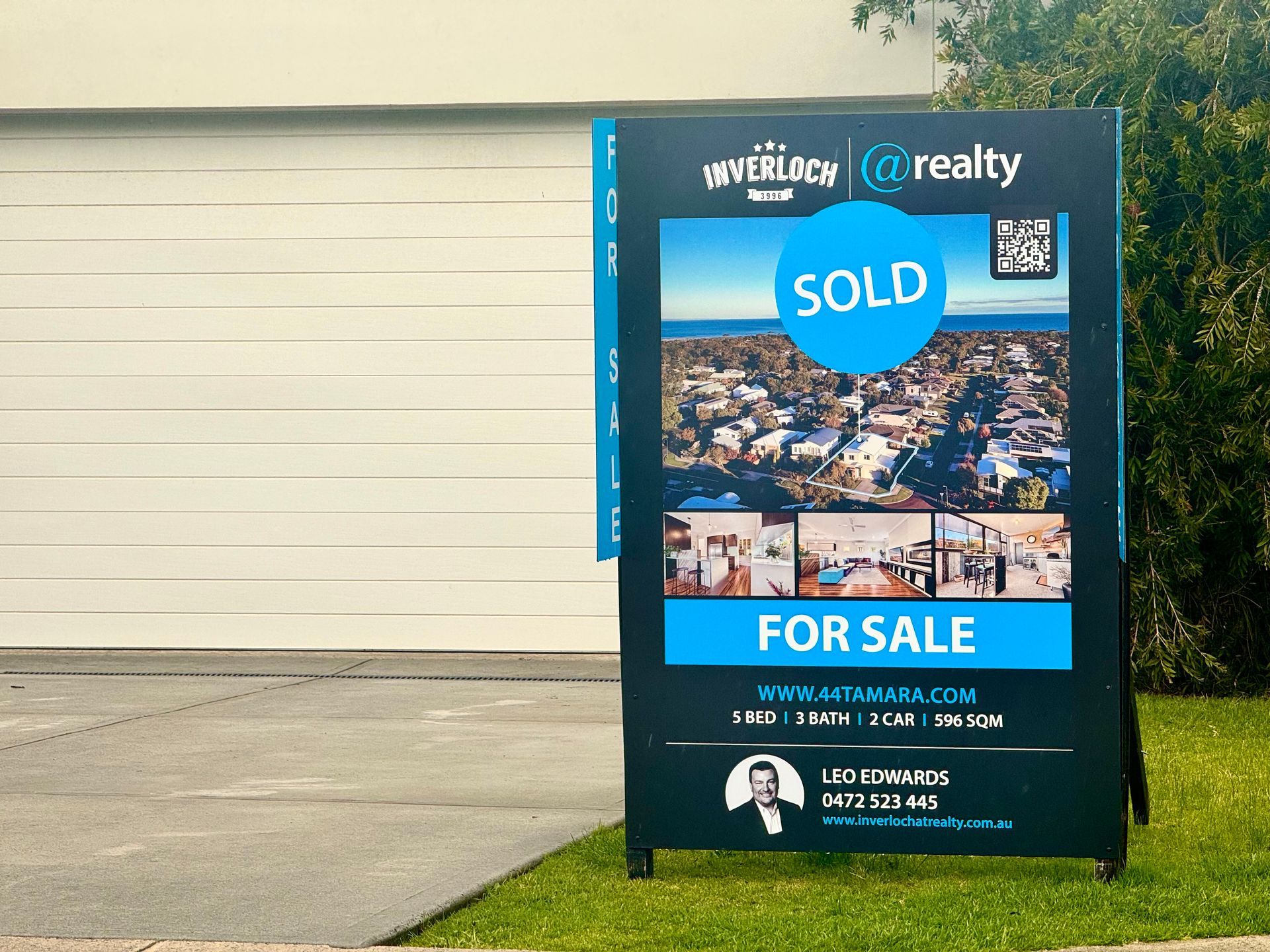 Real estate sign on lawn, 