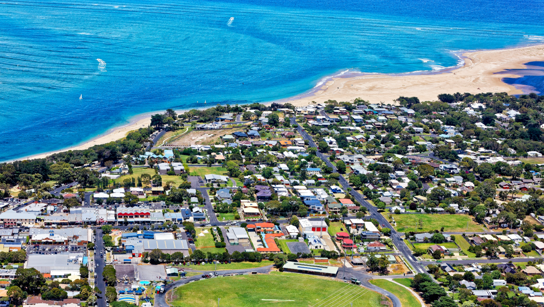 An aerial view of a small town next to the ocean.