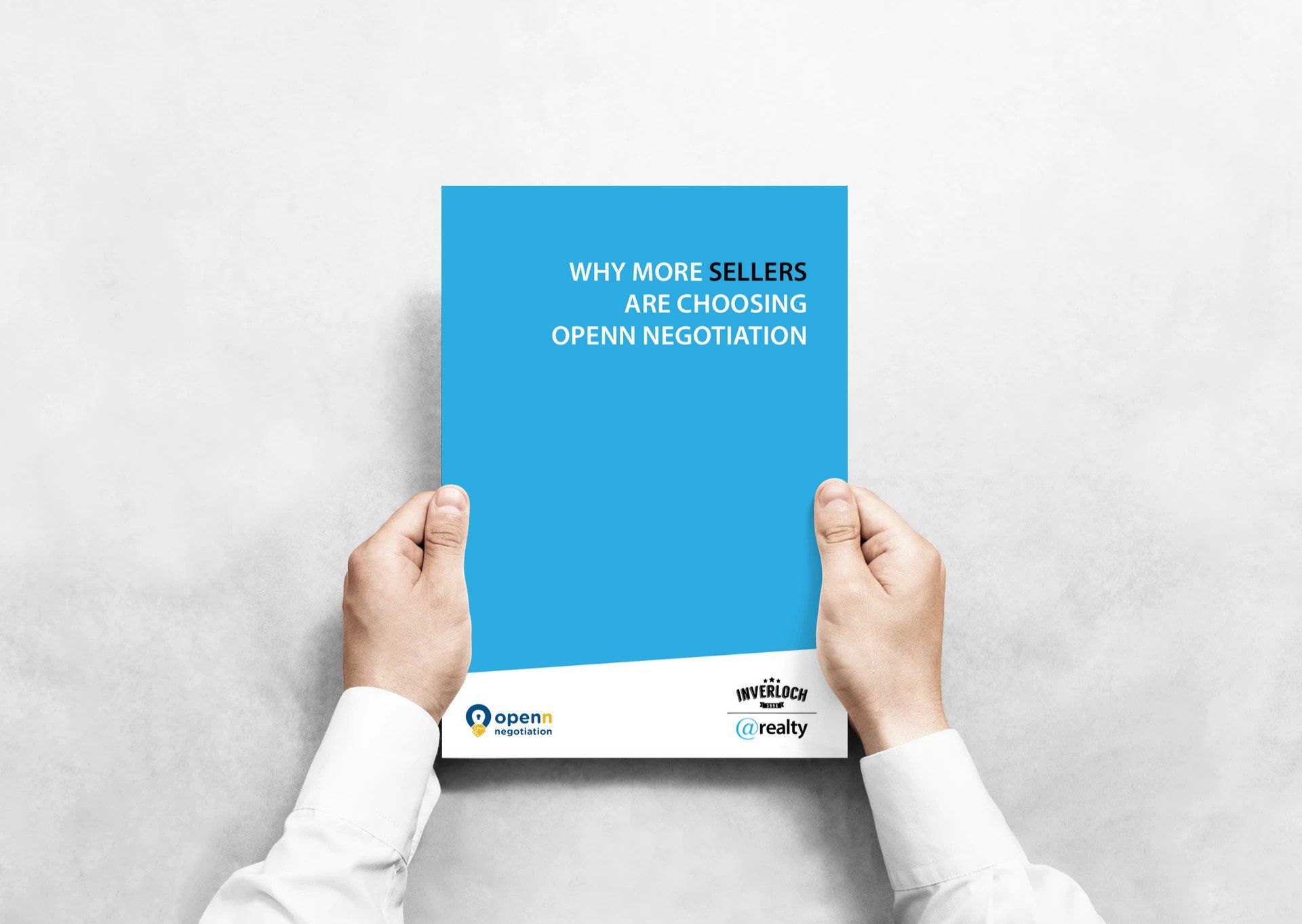 A person is holding a blue book in their hands.