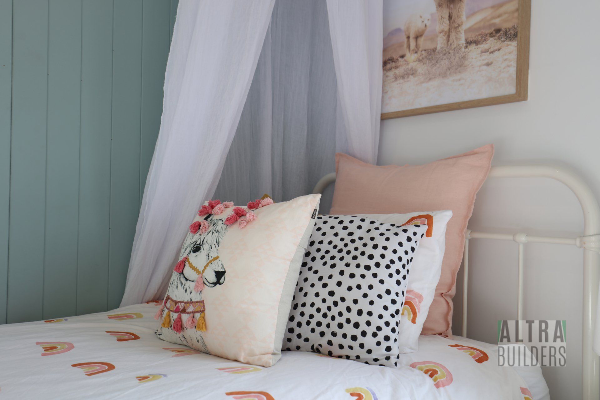 A bed with a canopy and pillows in a bedroom.