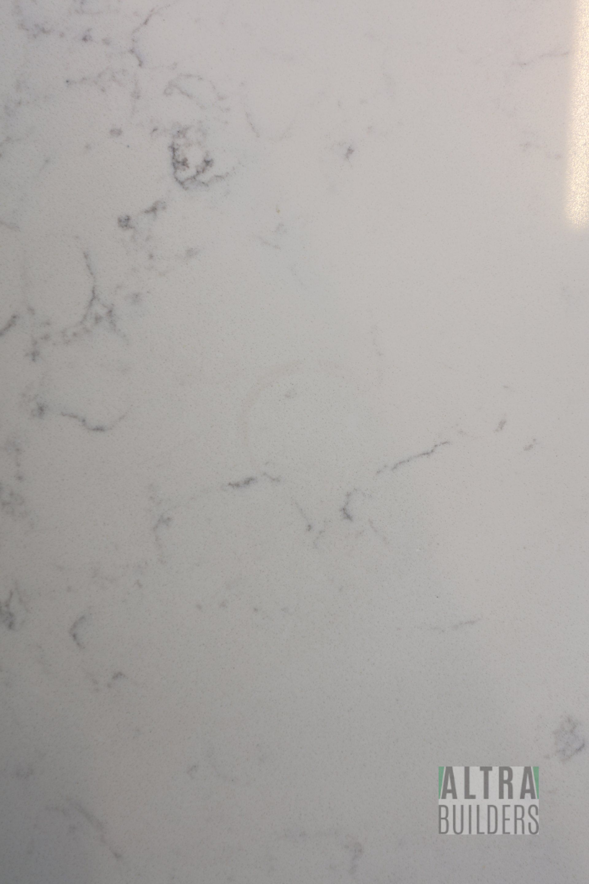 A close up of a white marble counter top.