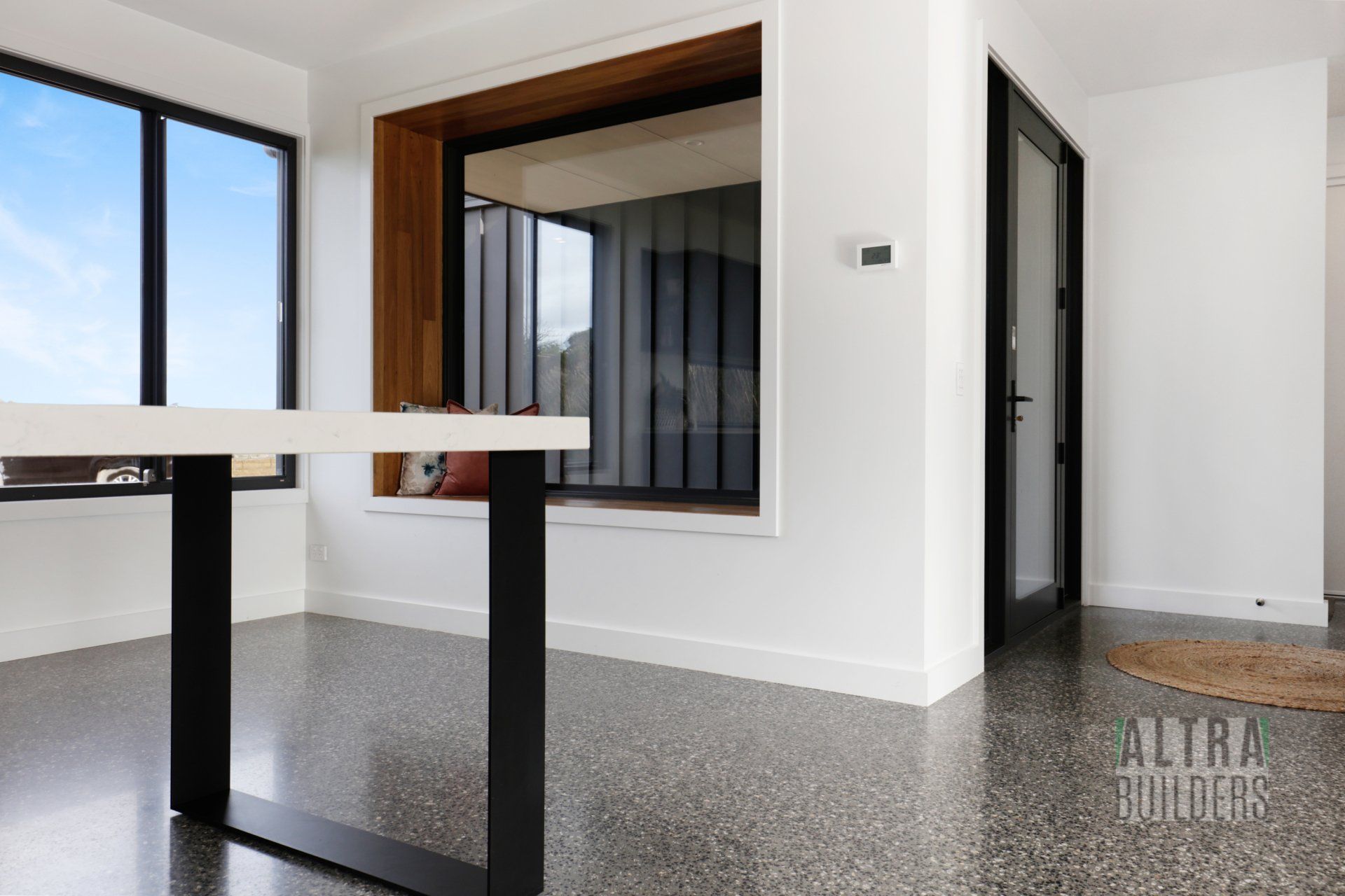 A living room with a table and a window.