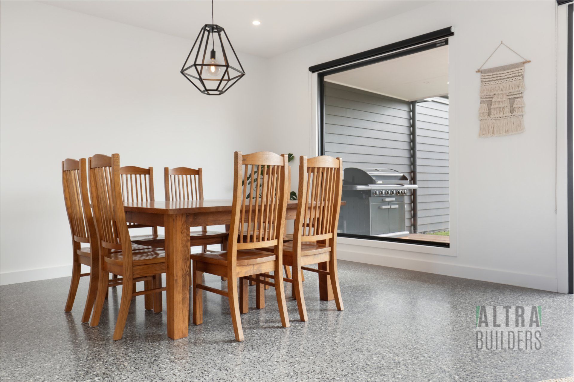 A dining room with a wooden table and chairs