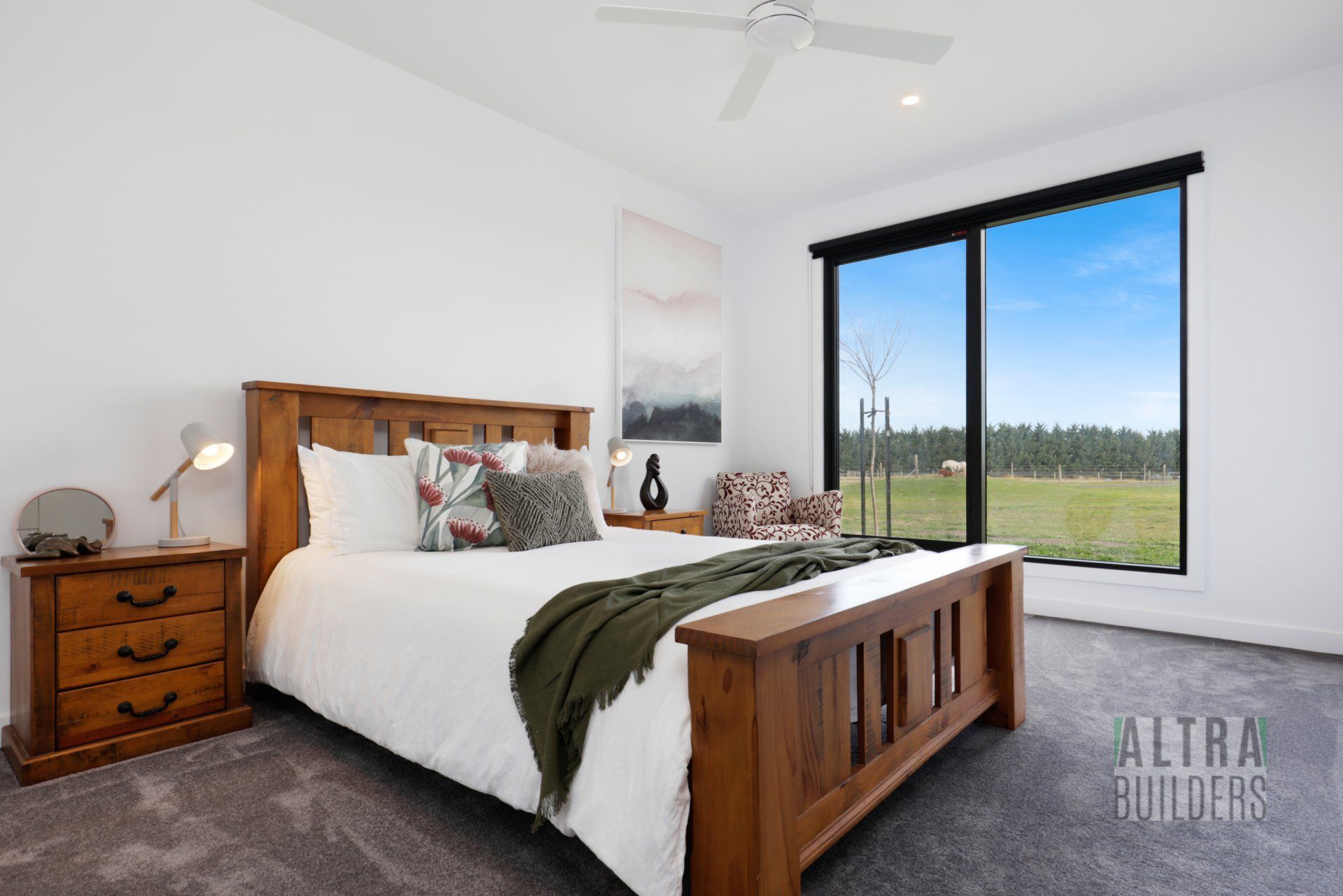 A bedroom with a large bed and a ceiling fan