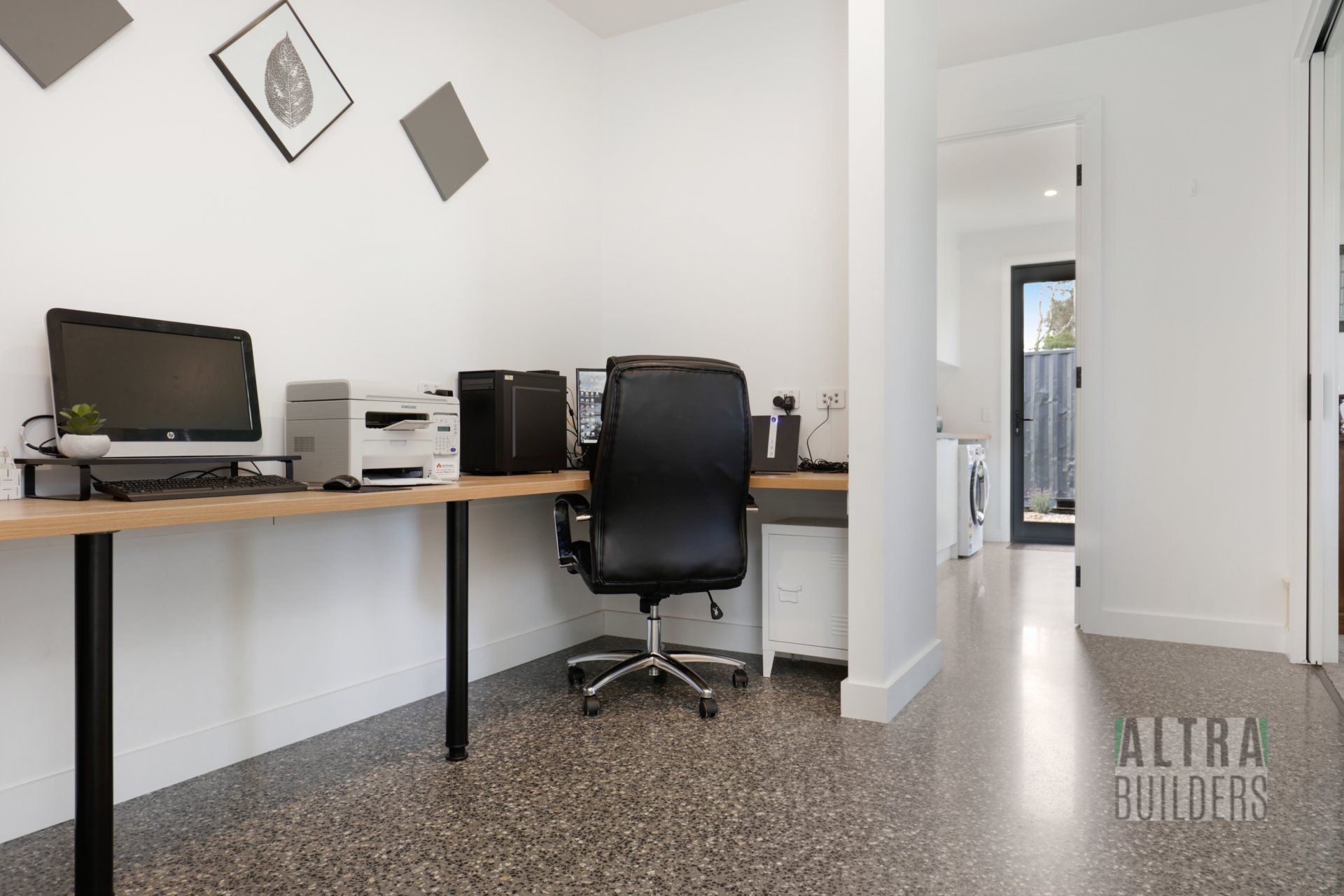 A home office with two desks and a chair