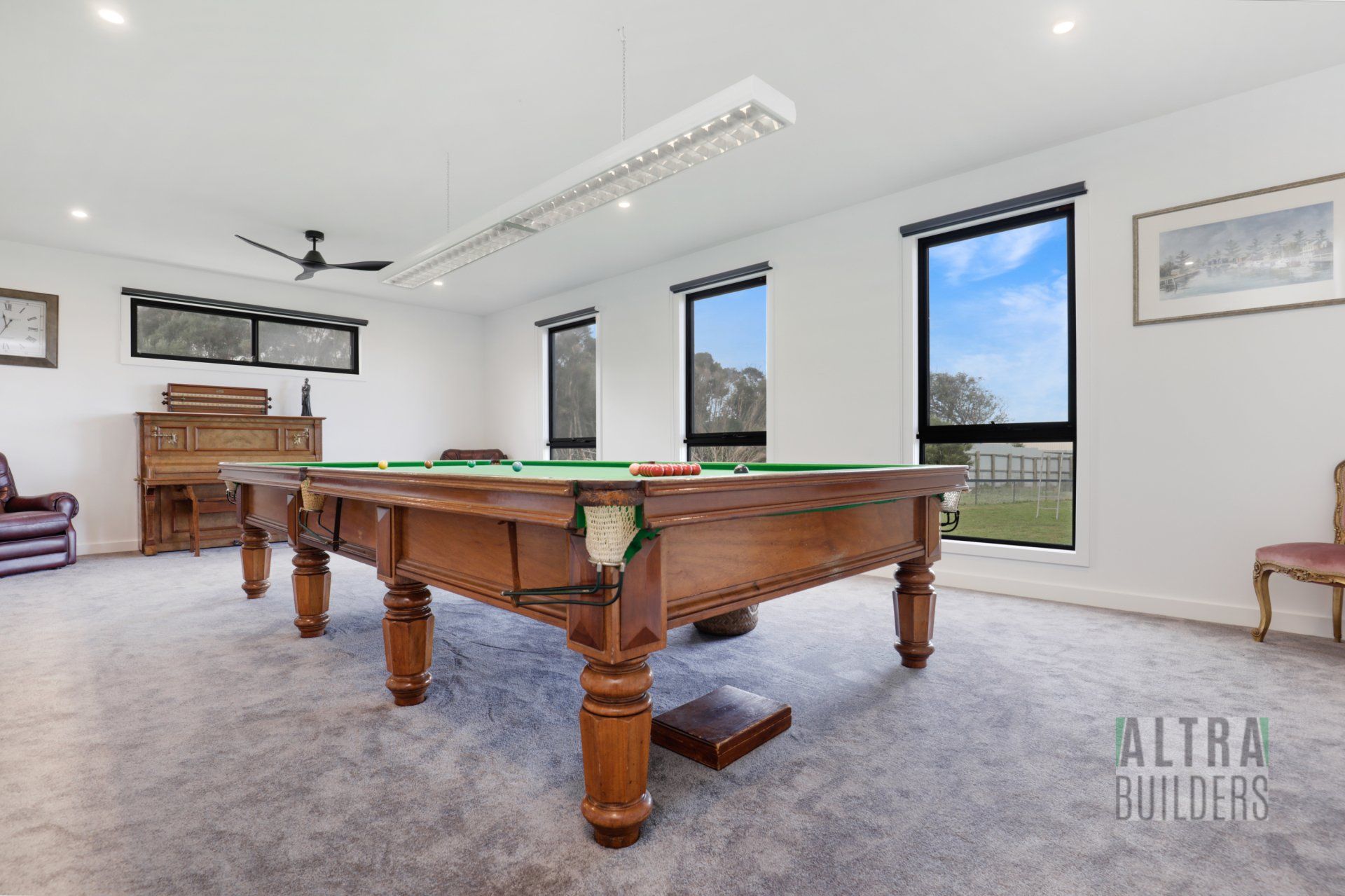 There is a pool table in the middle of the room.