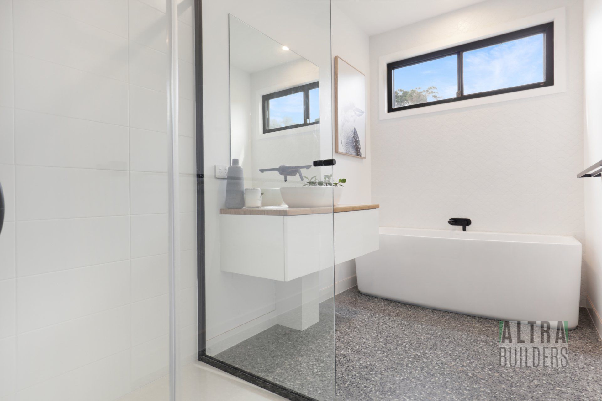 A bathroom with a bathtub , sink and shower.