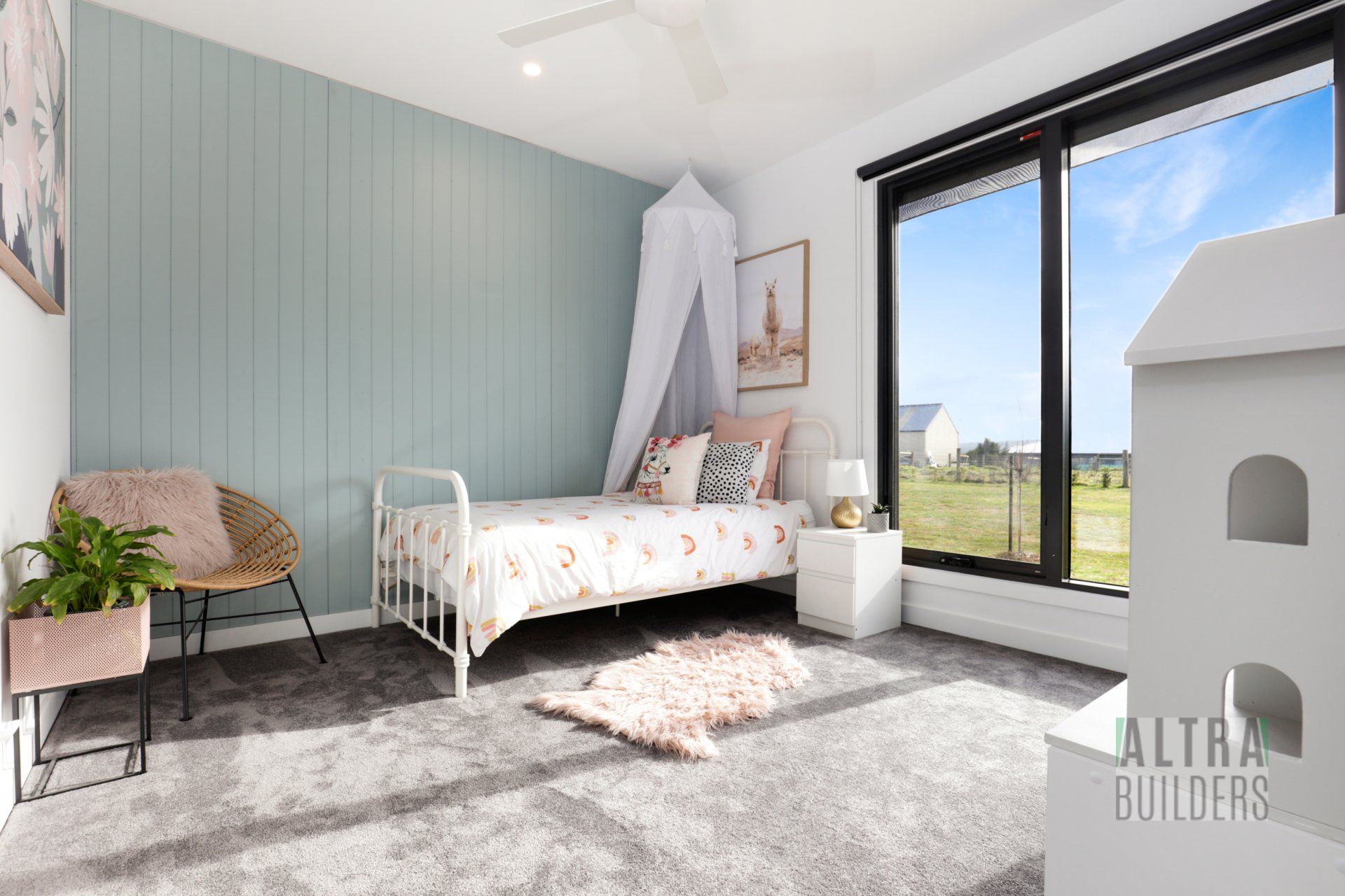 A bedroom with a bed , chair , nightstand and window.