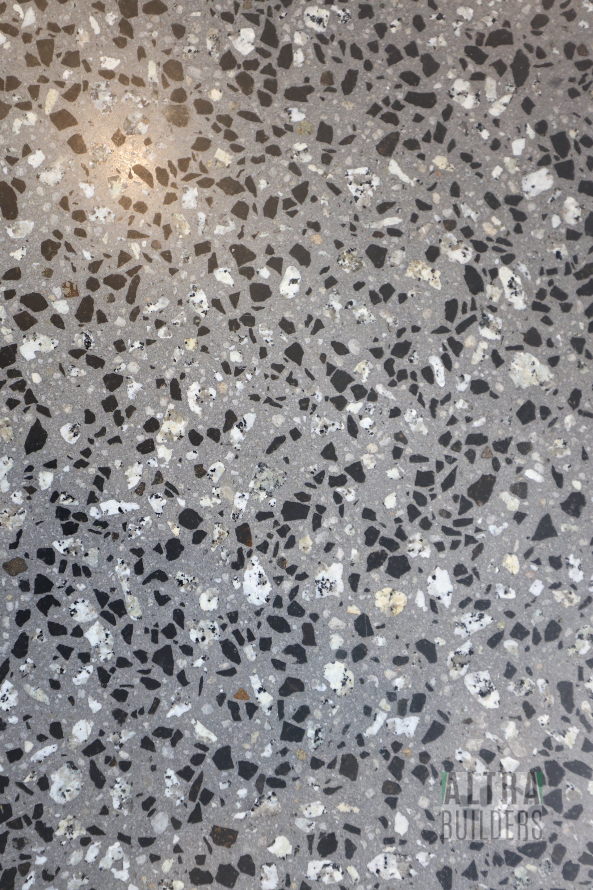 A close up of a black and white terrazzo floor.