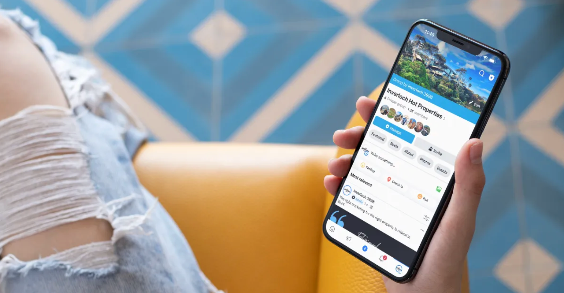 Person holding smartphone, showing a travel app with a scenic mountain image.