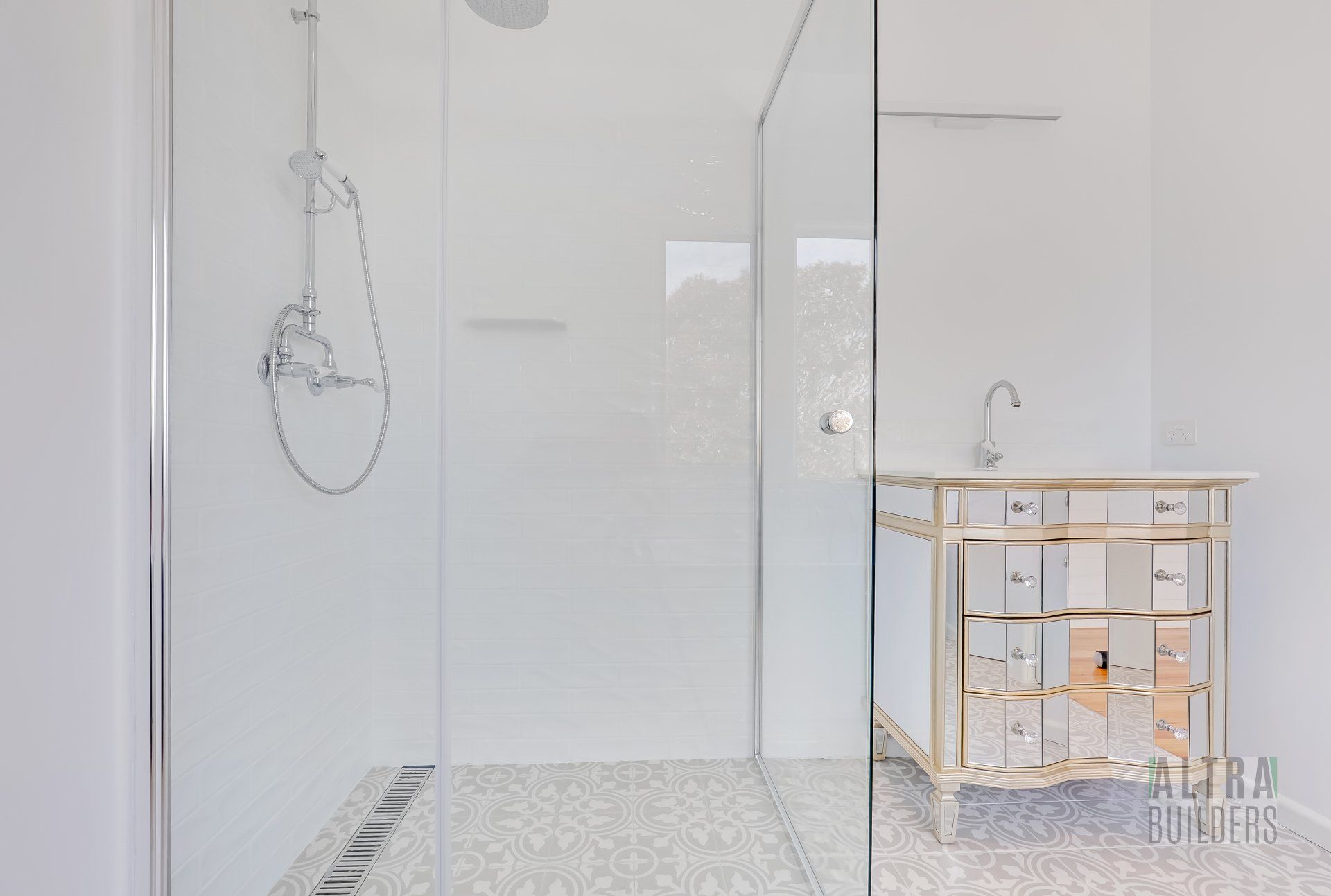 A bathroom with a walk in shower and a sink.