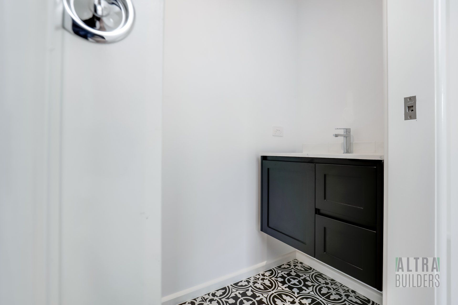 A bathroom with a sink and a mirror on the wall.