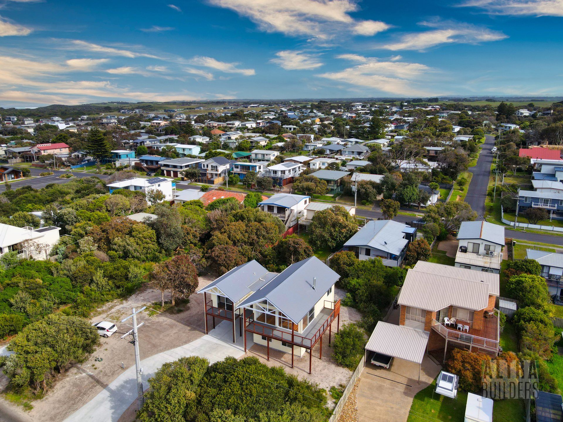 An aerial view of a residential area with houses and trees