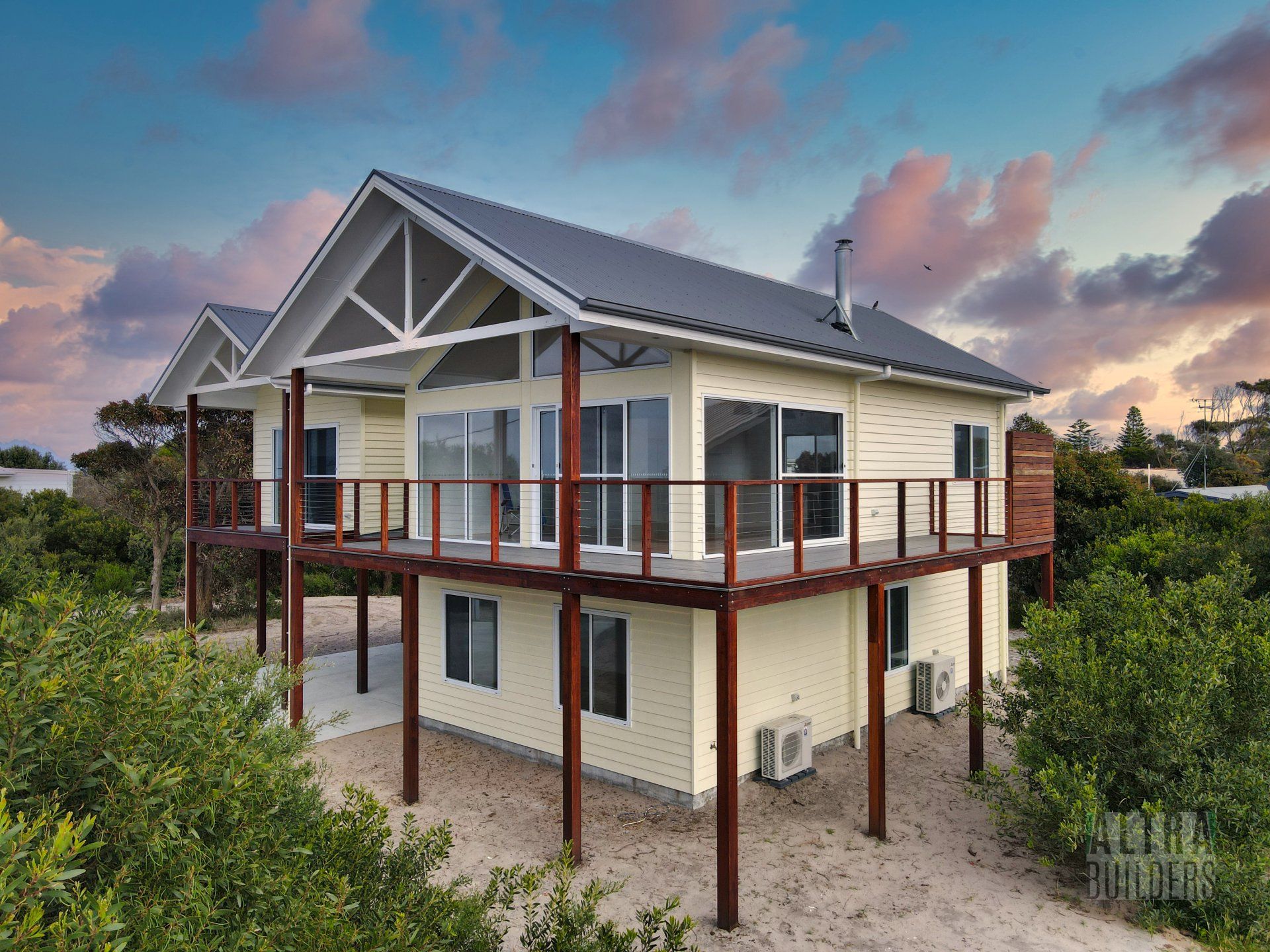 A house with a large deck on top of it