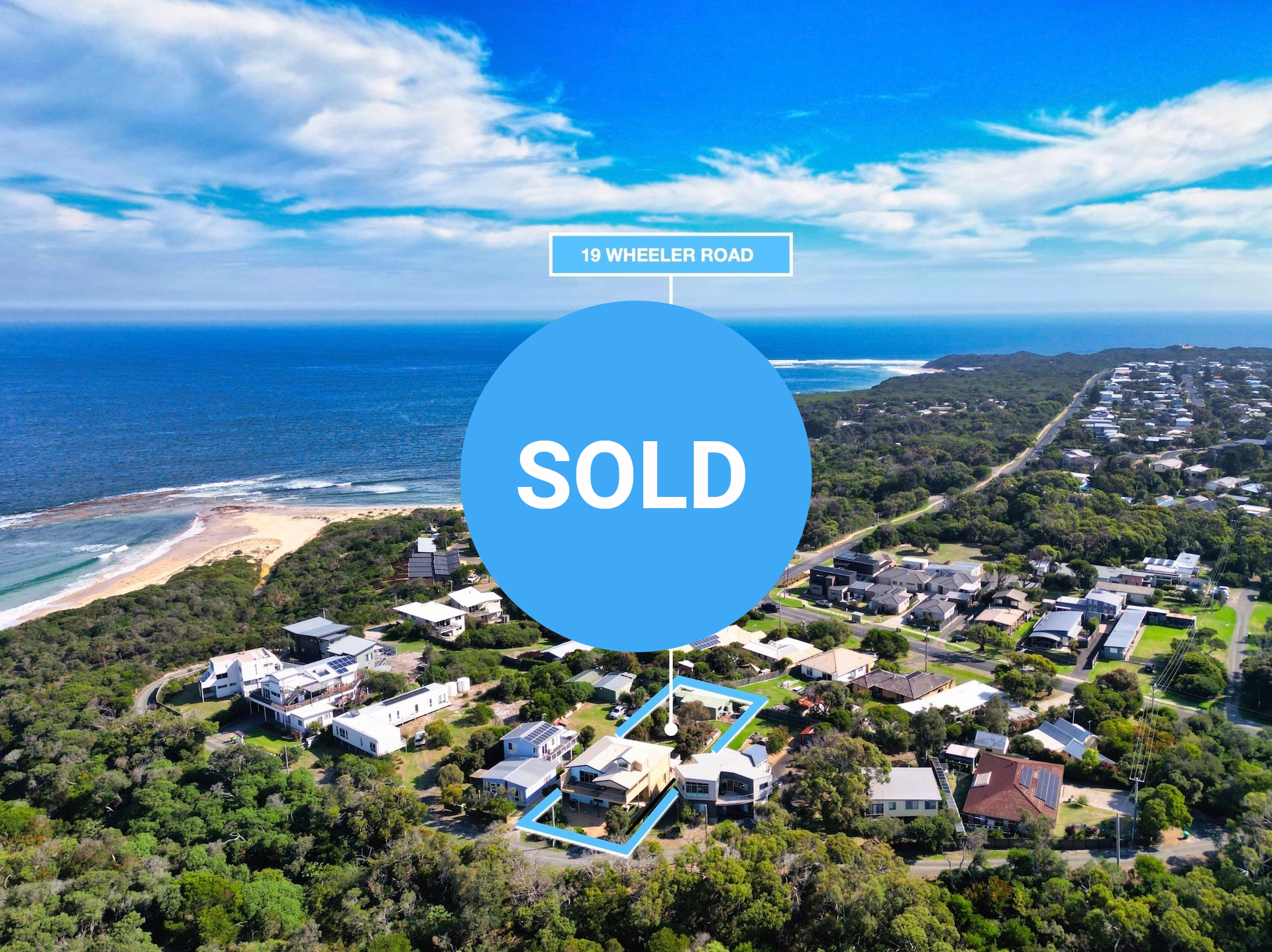Aerial view of a coastal neighborhood with a light blue outline highlighting a property near a beach and ocean.