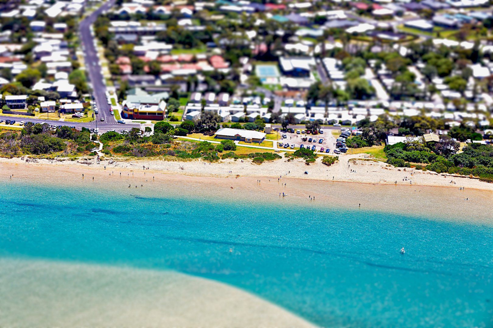 An aerial view of a beach with a city in the background