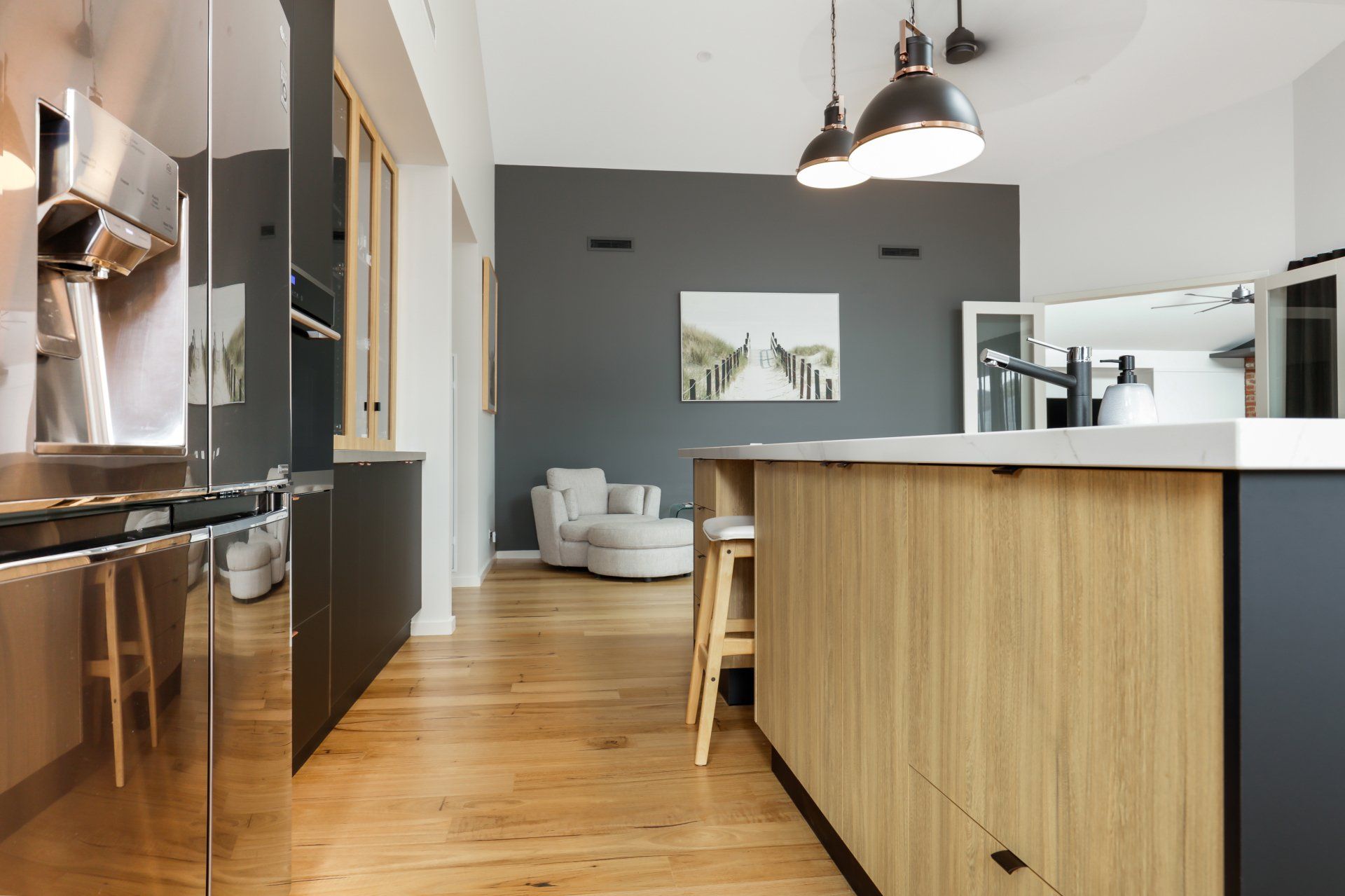 A kitchen with stainless steel appliances , wooden cabinets , and a large island.