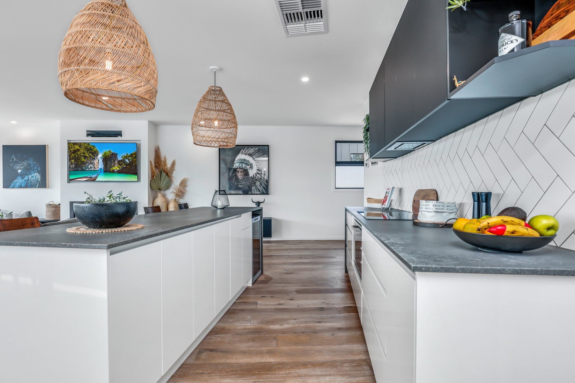 A kitchen with a bowl of fruit on the counter.