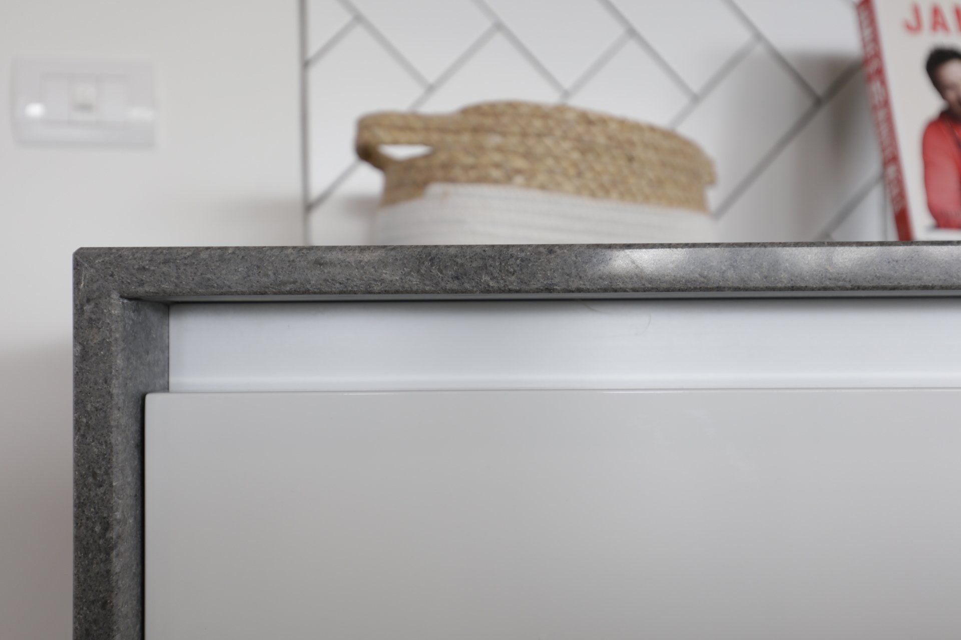 A close up of a kitchen counter with a basket on top of it.