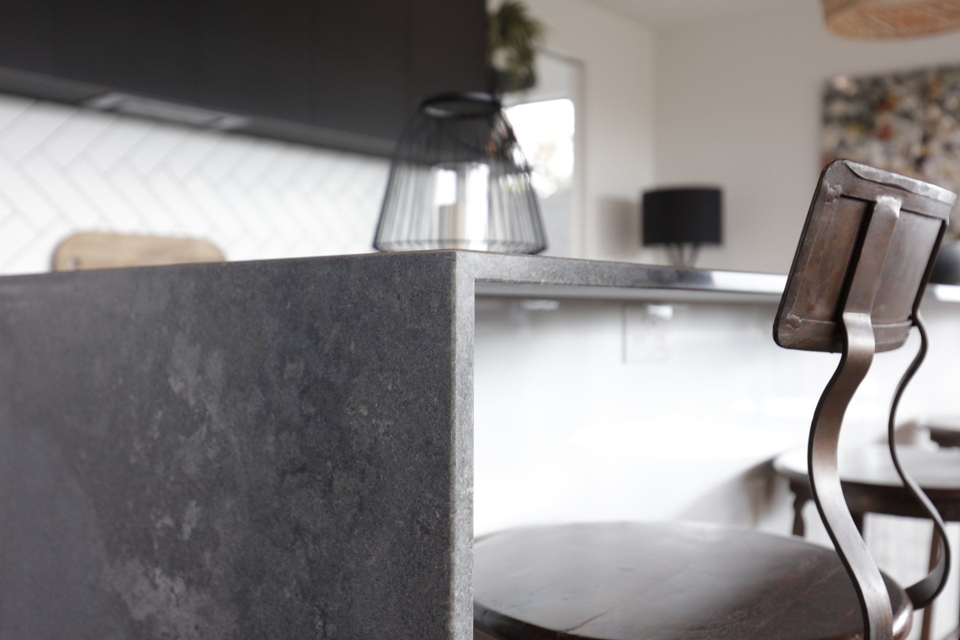 A chair is sitting in front of a counter in a kitchen.