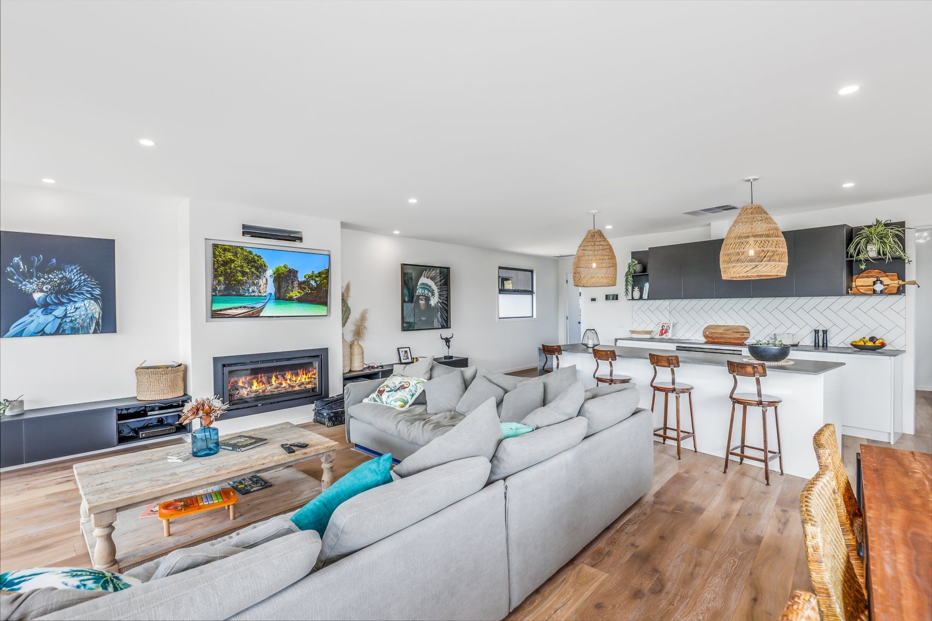 A living room with a large couch and a fireplace.