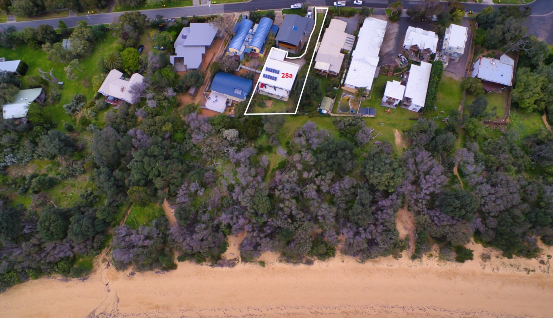 An aerial view of a residential area next to a beach.