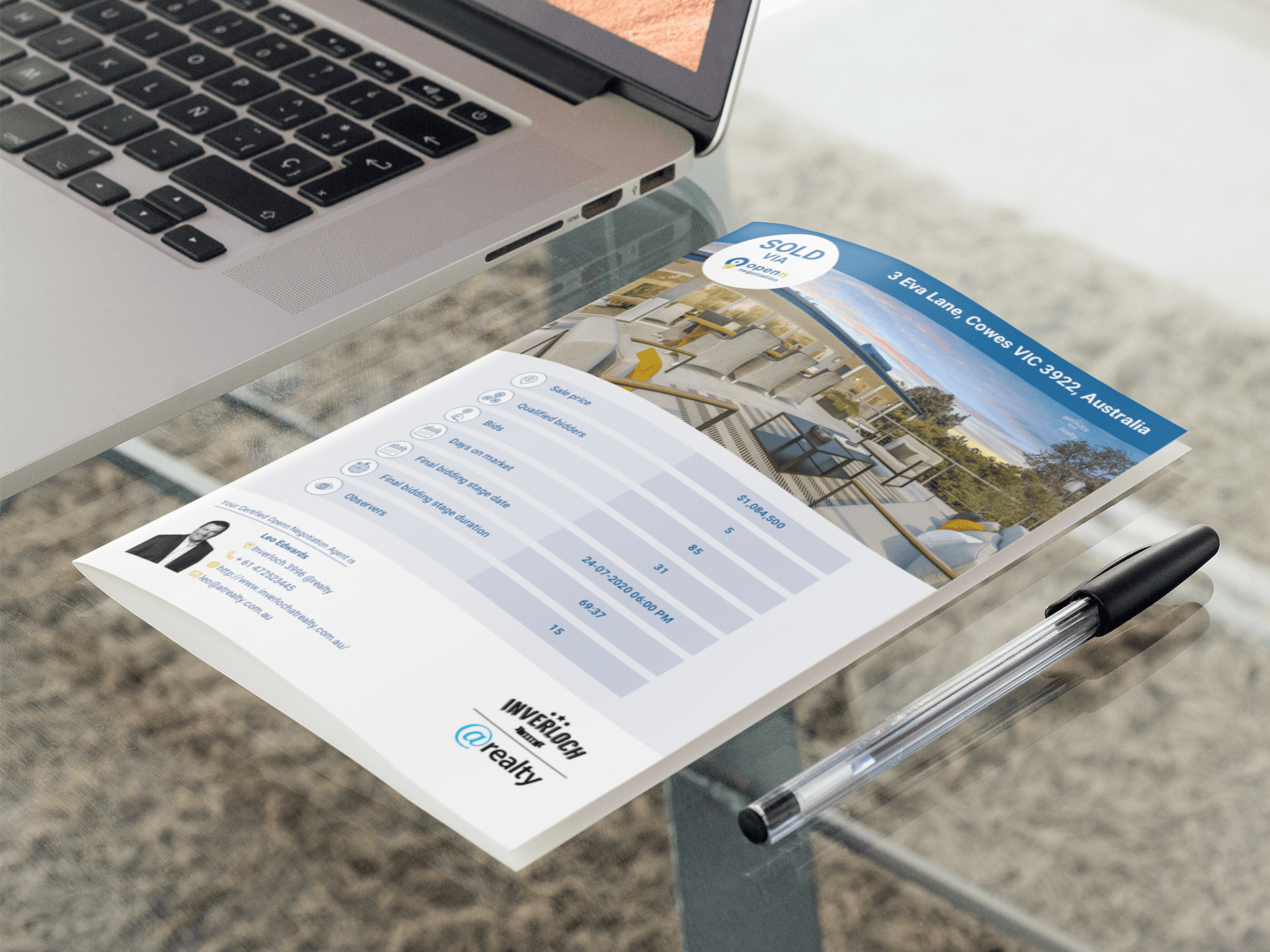 A piece of paper is sitting on a desk next to a laptop and a pen.