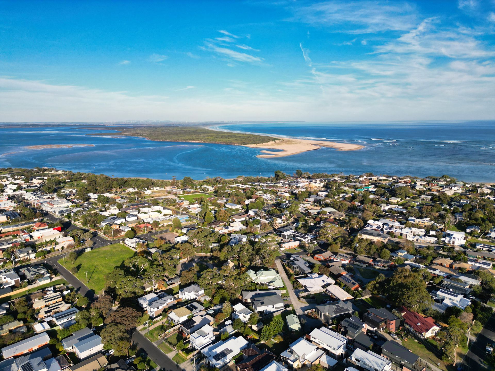 An aerial view of a residential area next to a body of water.